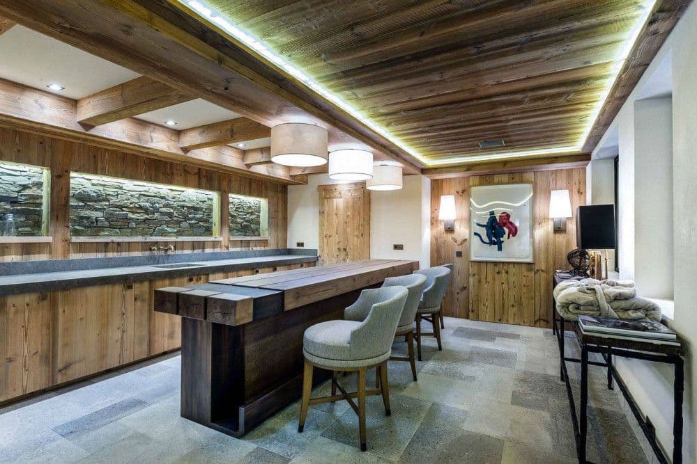 Chalet bar with stools and a timber counter at Courchevel 16