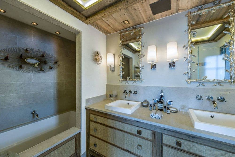 En-suite bathroom with a double vanity and bath at Courchevel 16