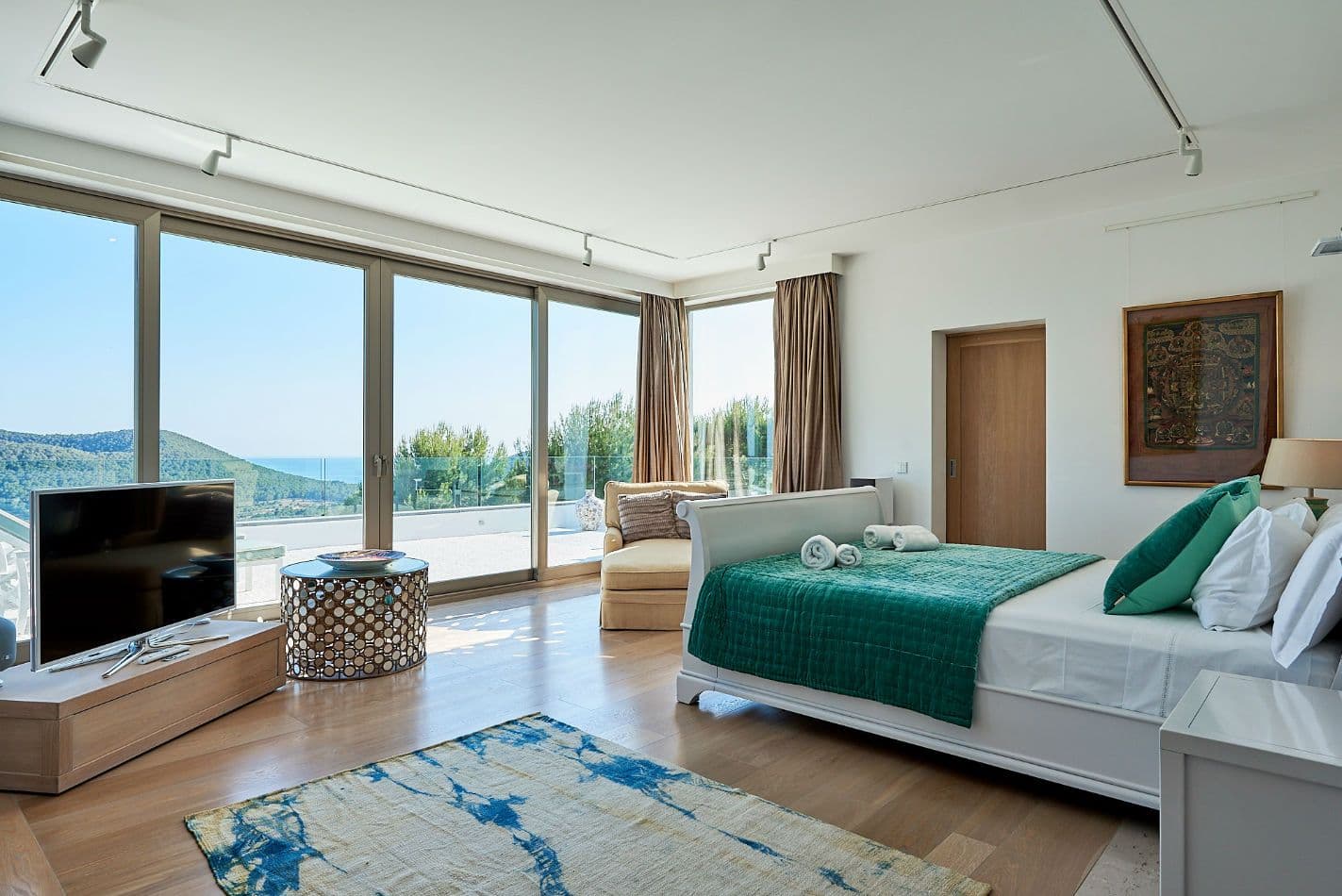 Guest bedroom with teal accents and countryside views at Somewhere On The Horizon