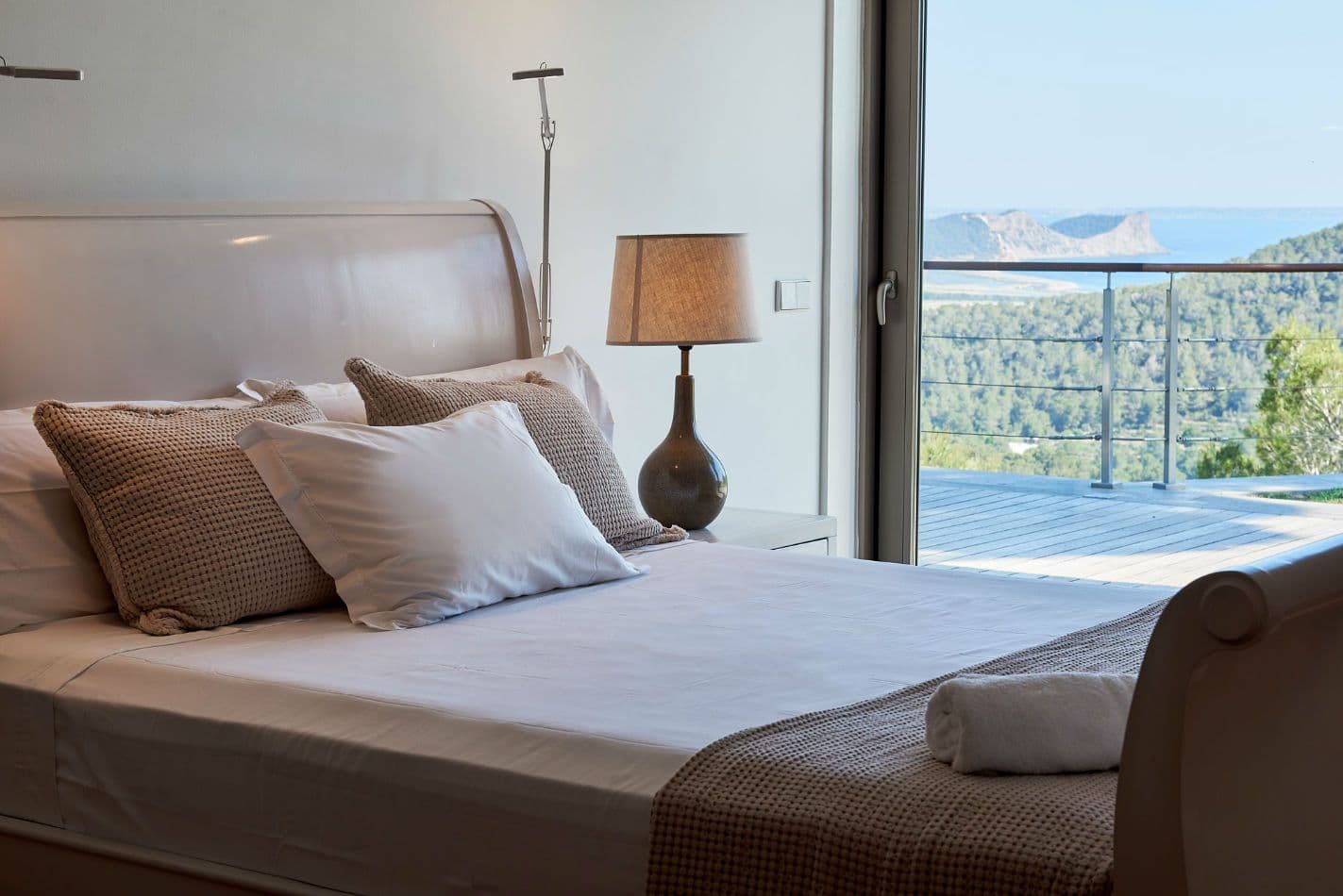 Bedroom in neutral tones with floor-to-ceiling windows at Somewhere On The Horizon