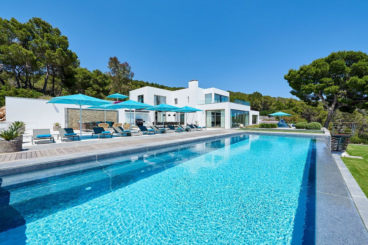 Somewhere On The Horizon, a contemporary white villa in Ibiza with a long infinity pool
