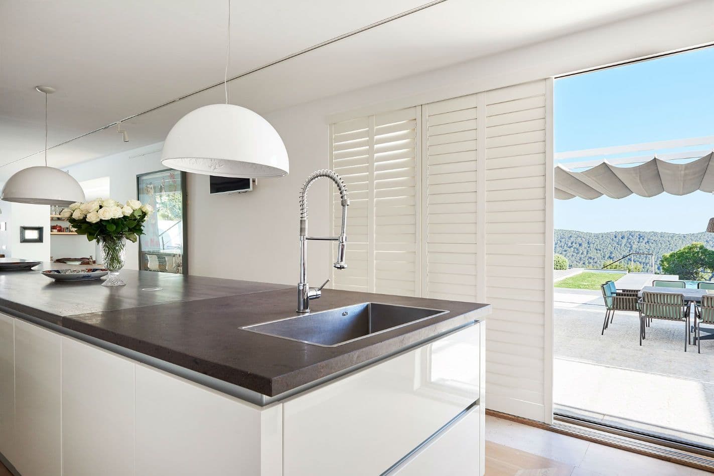 Kitchen island with sink and dark countertop at Somewhere On The Horizon