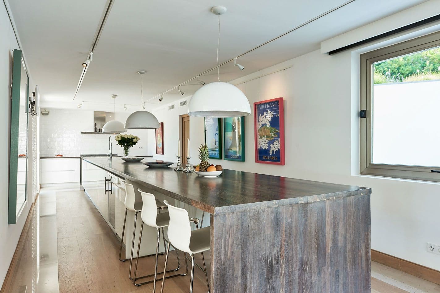 Kitchen with a long bar-height dining counter and pendant lights at Somewhere On The Horizon