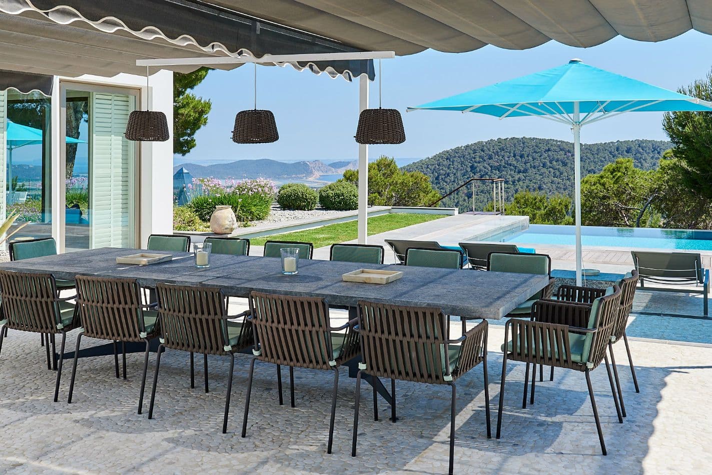 Covered outdoor dining table beside the pool at Somewhere On The Horizon