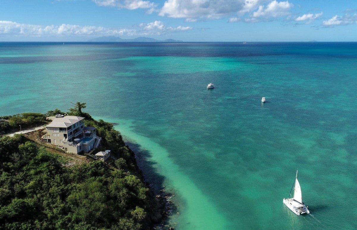 Aerial view of Sea Breeze Cove on the tip of Reed's Point surrounded by turquoise sea