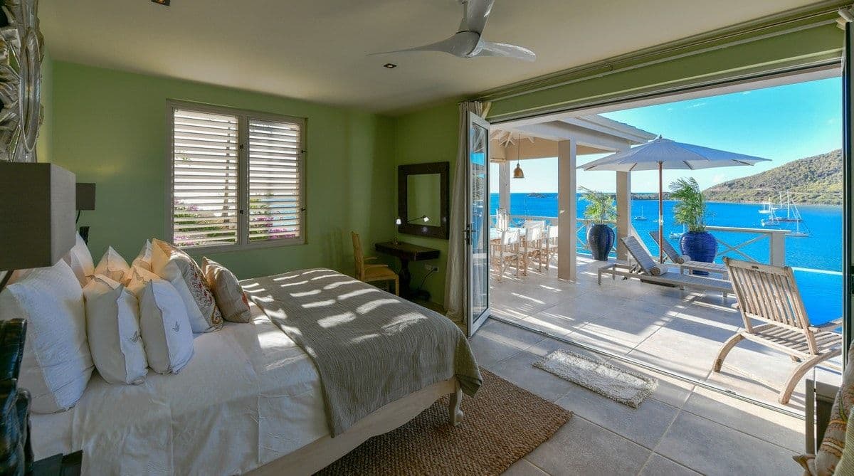 Bedroom opening to a private terrace and sea view at Sea Breeze Cove