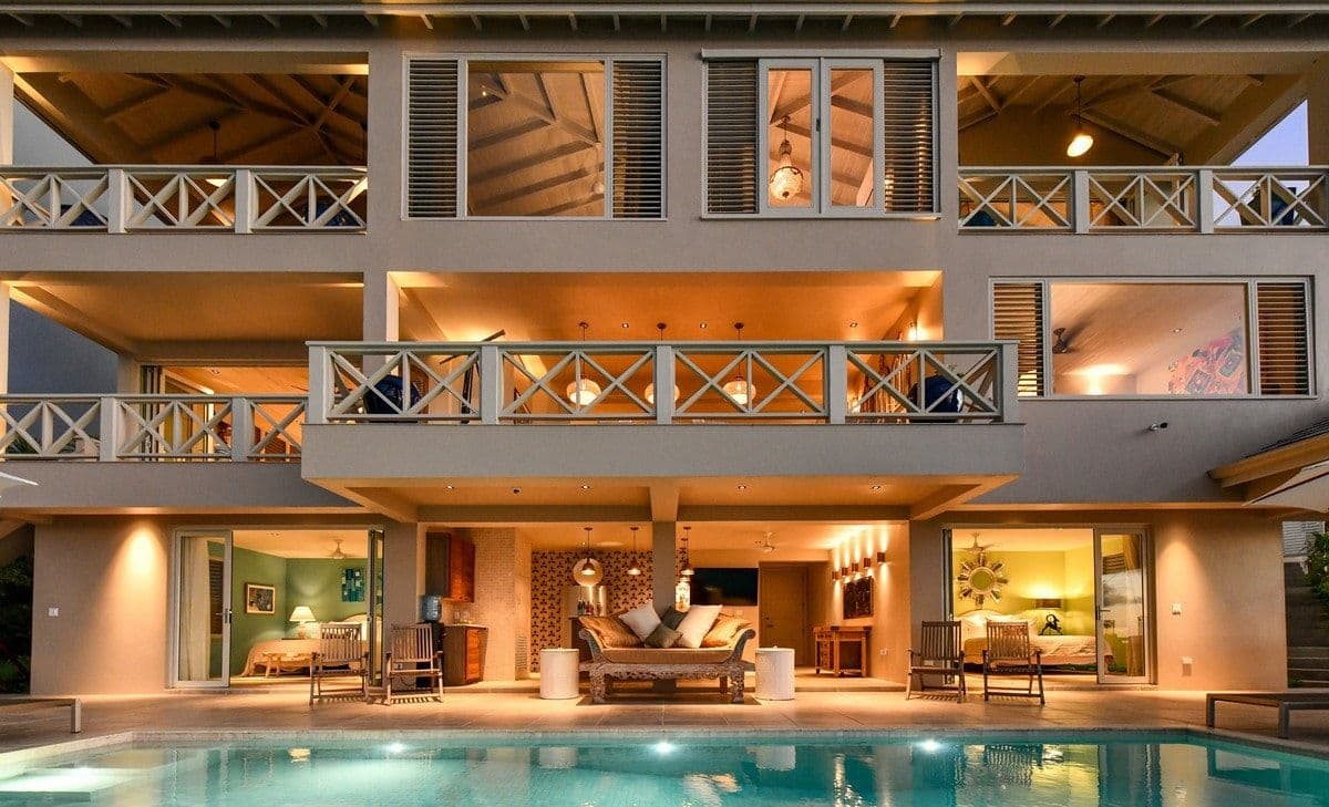 Sea Breeze Cove villa facade illuminated at twilight across its three levels