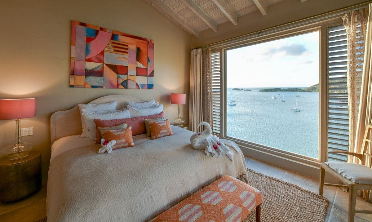 Guest bedroom with bold artwork and sea view at Sea Breeze Cove