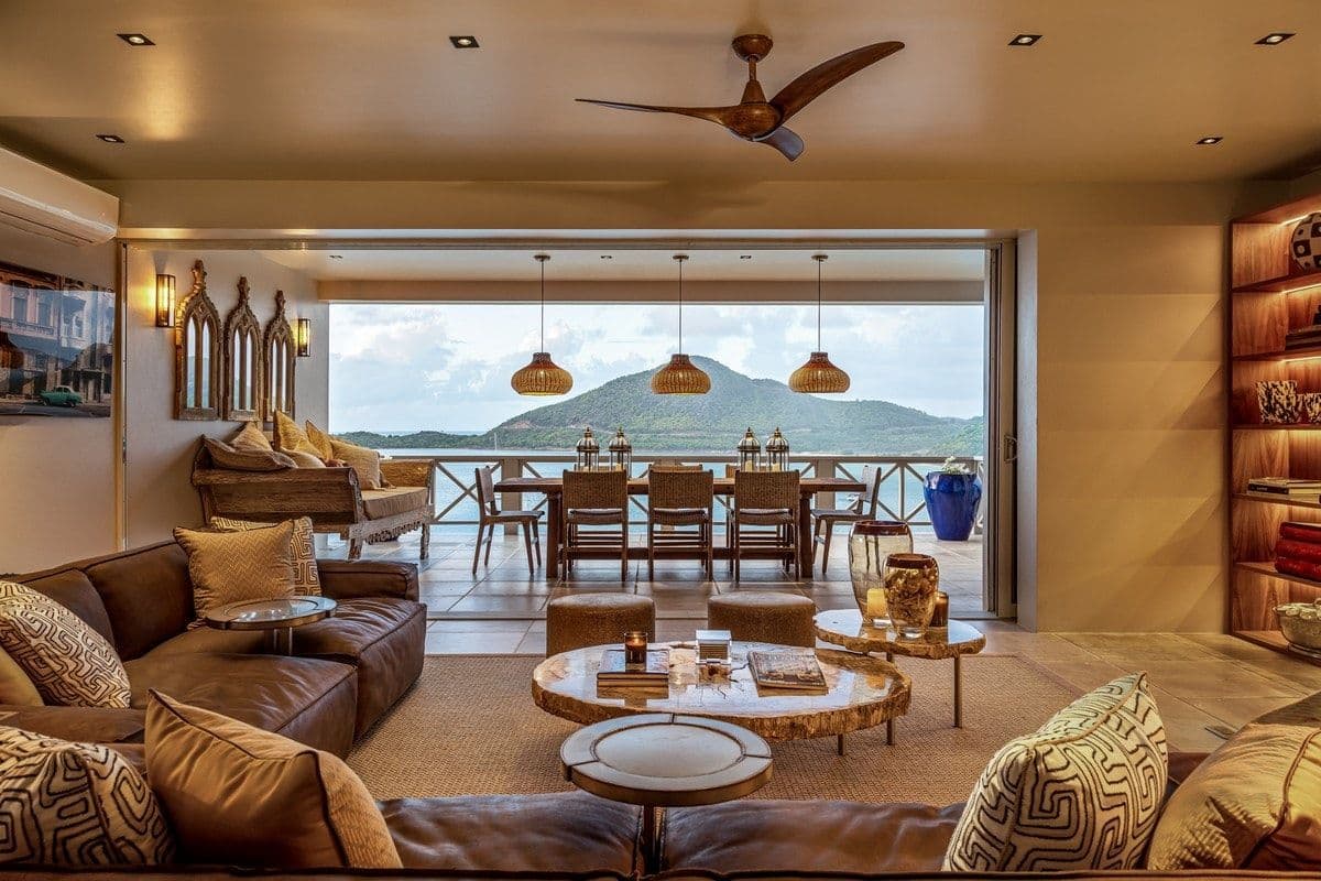 Open living room at Sea Breeze Cove with leather sofas opening to the terrace and sea