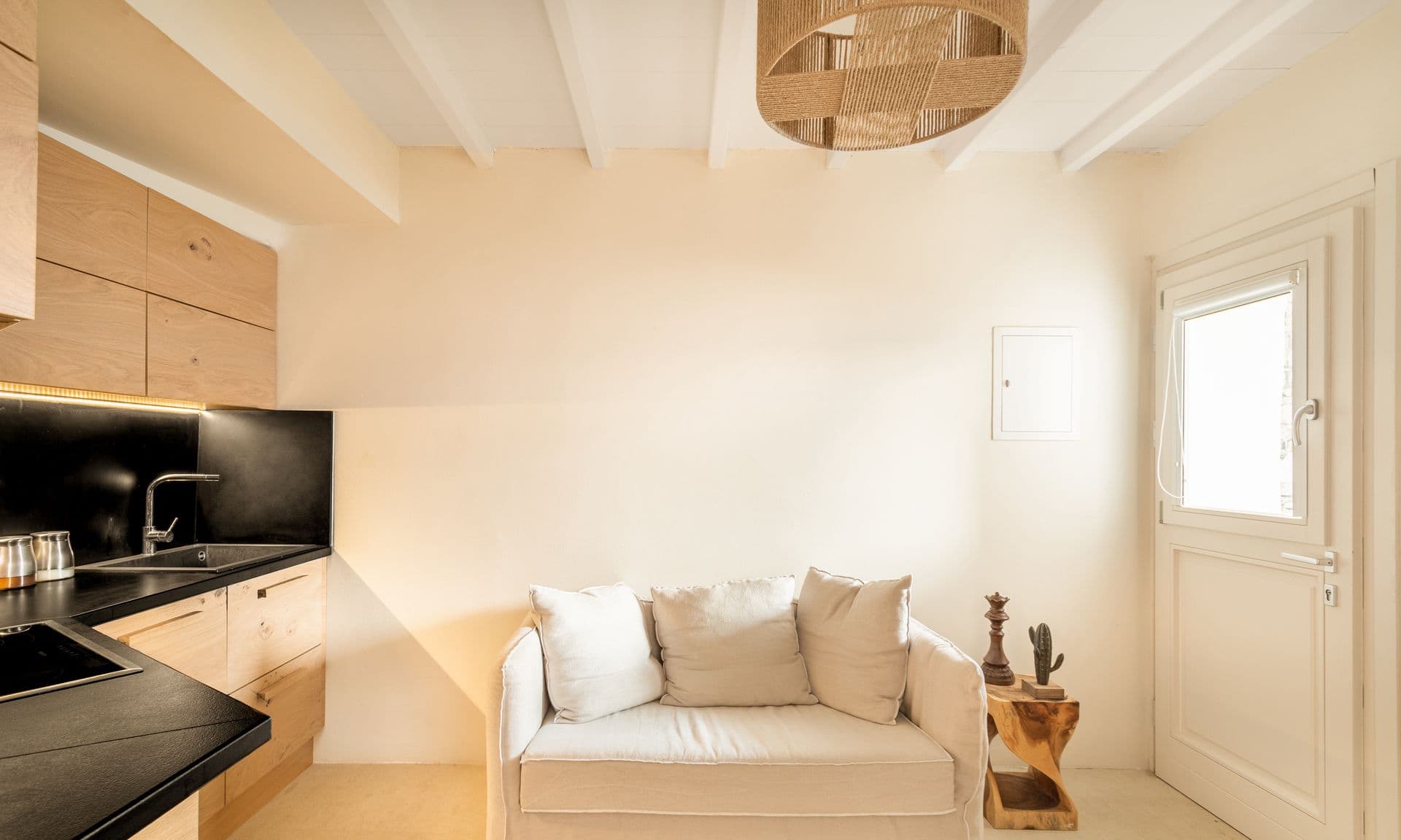 Cosy living space seen through an arched white doorway