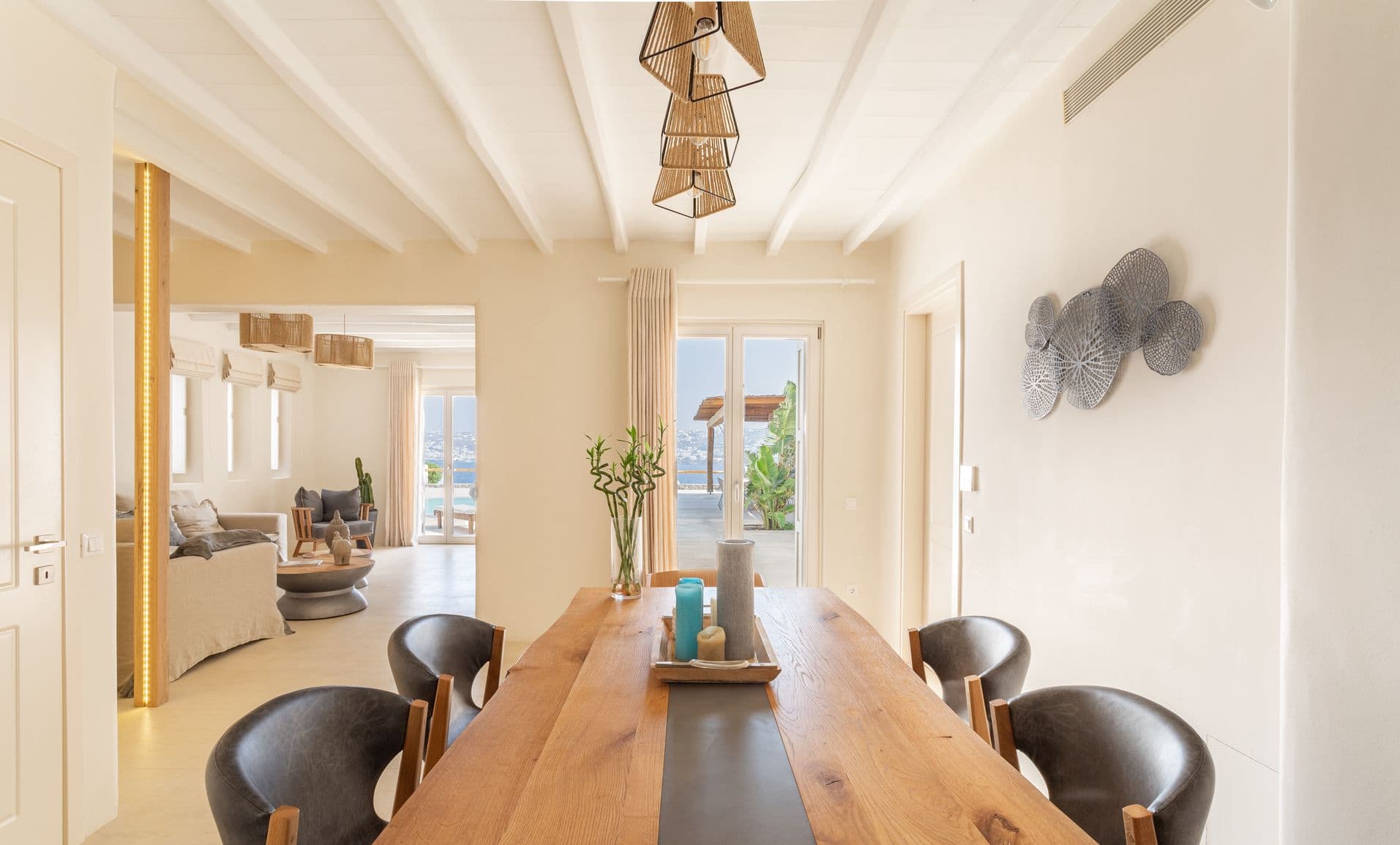 Bright living room with beige sofas, wood coffee tables and sea-view window