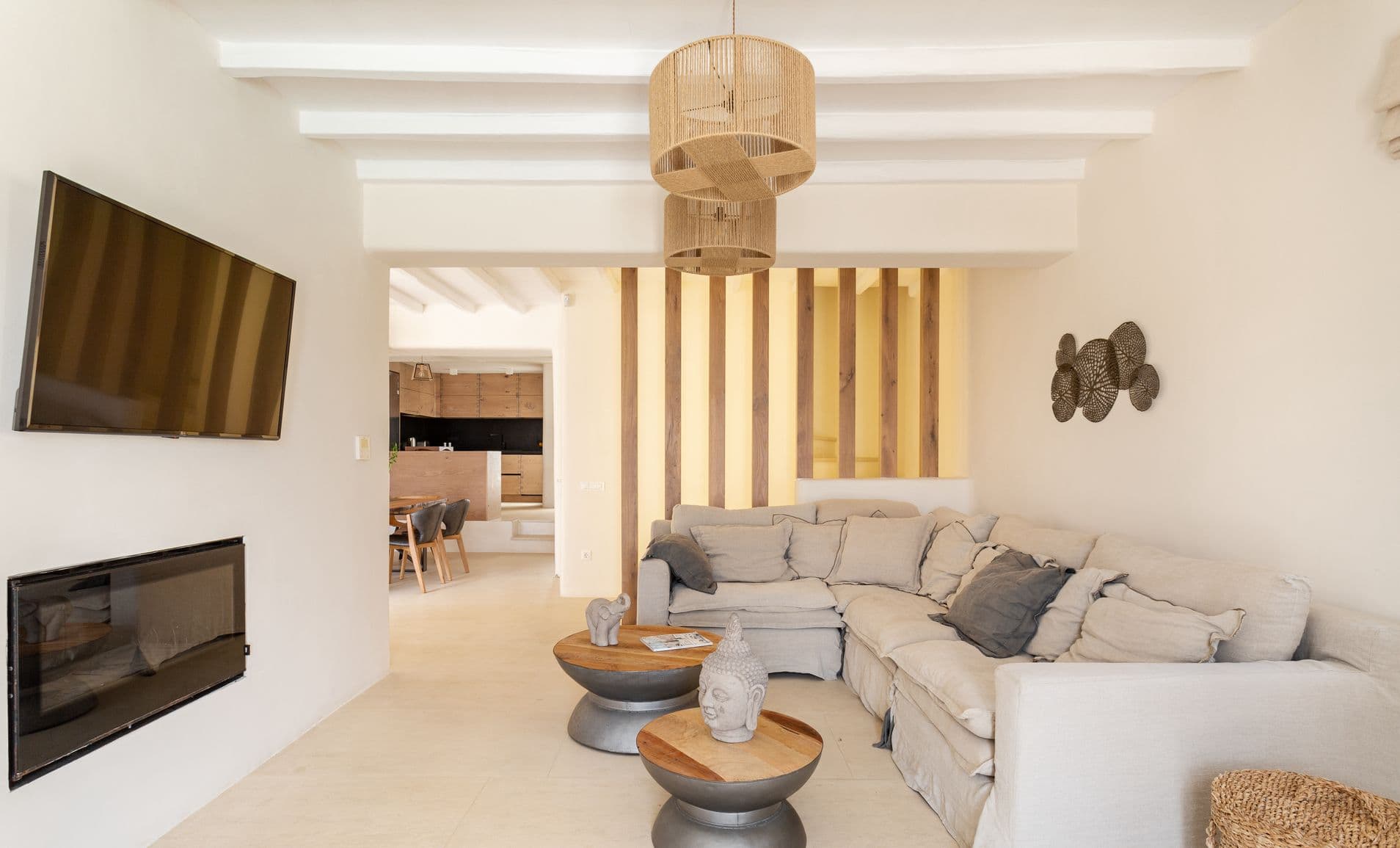 Open-plan living space with grey corner sofa flowing into the dining area