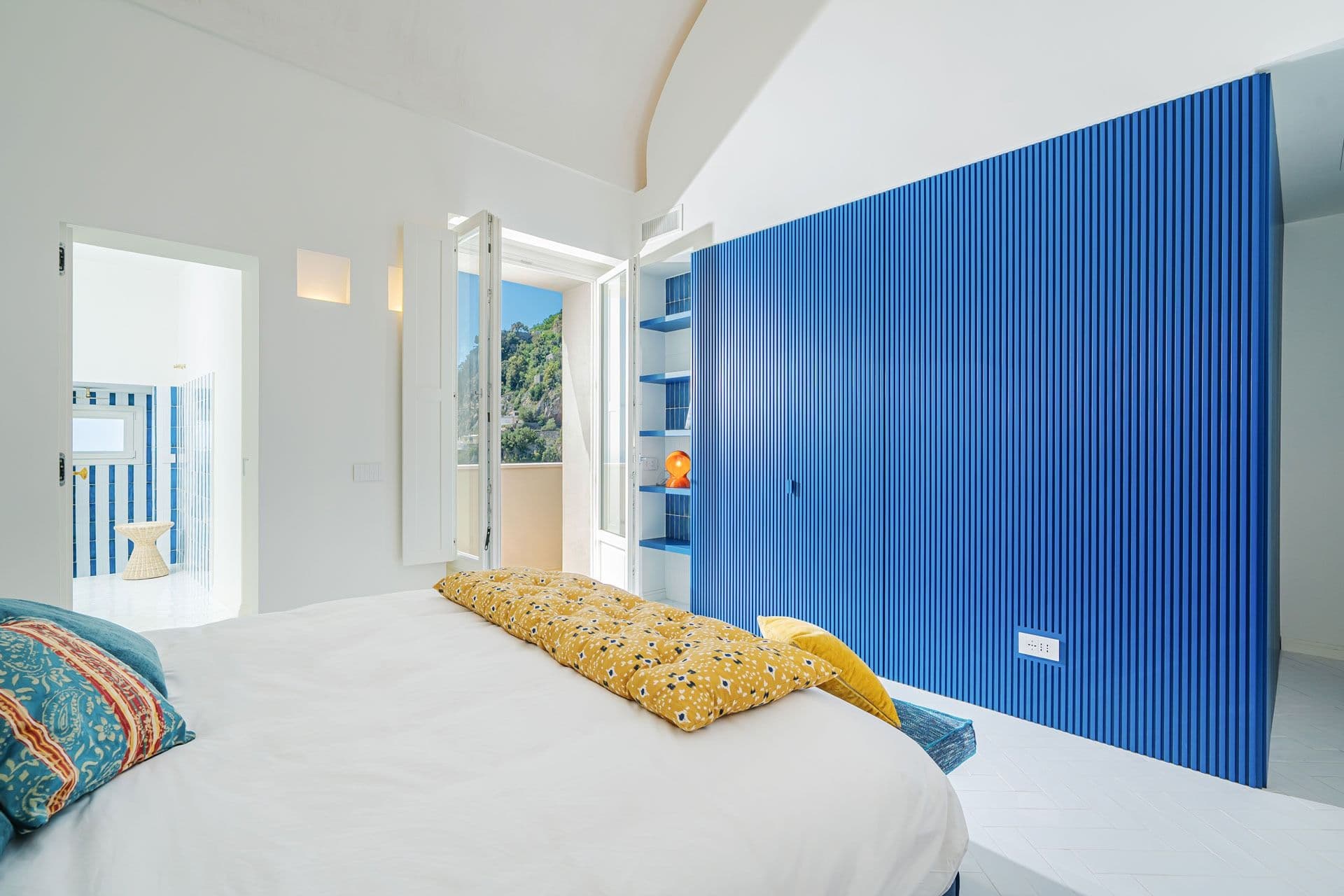 Bedroom with cobalt panelled wall at Ocean House, Positano