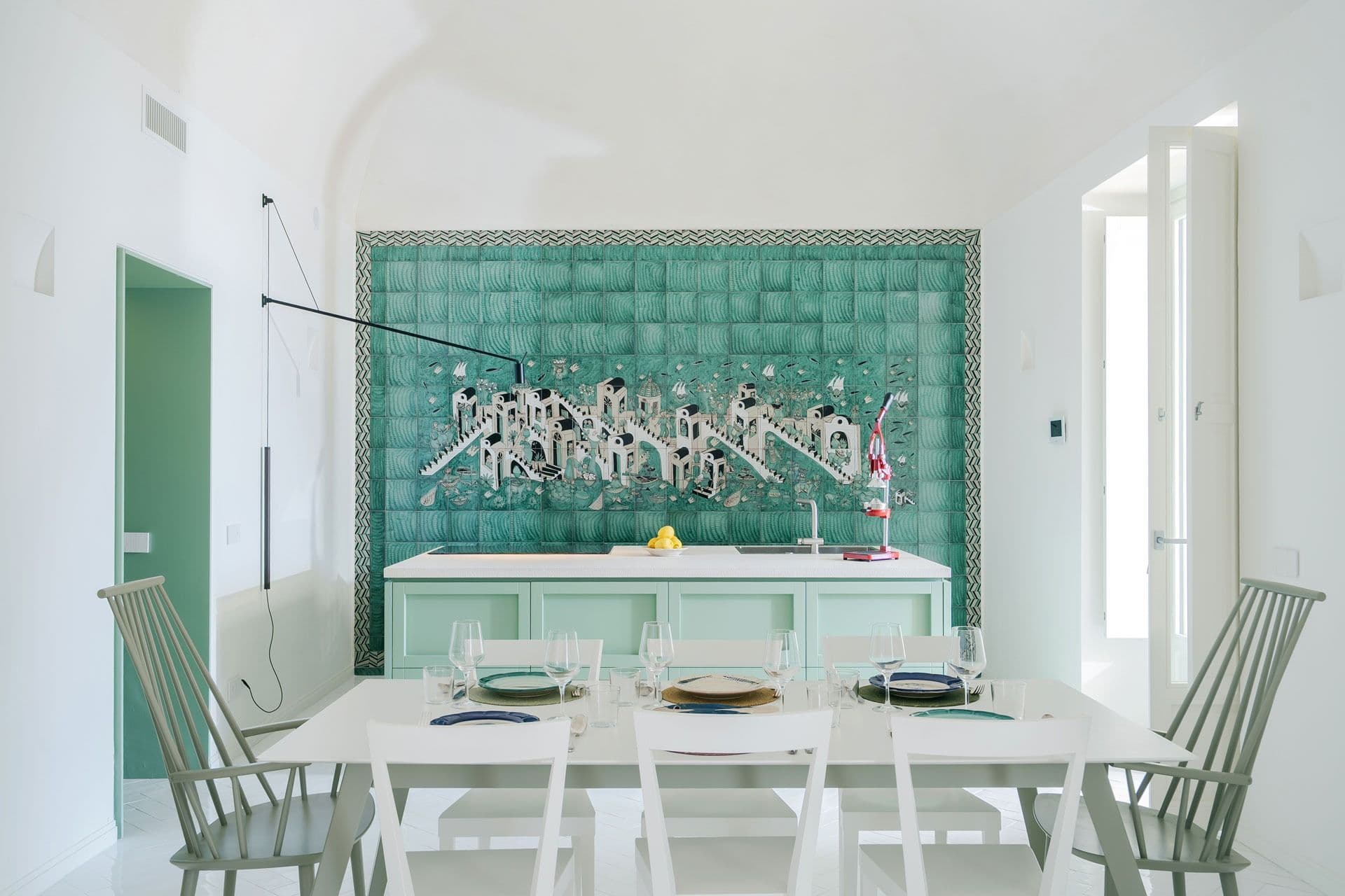 Green-tiled kitchen opening to a dining area at Ocean House, Positano