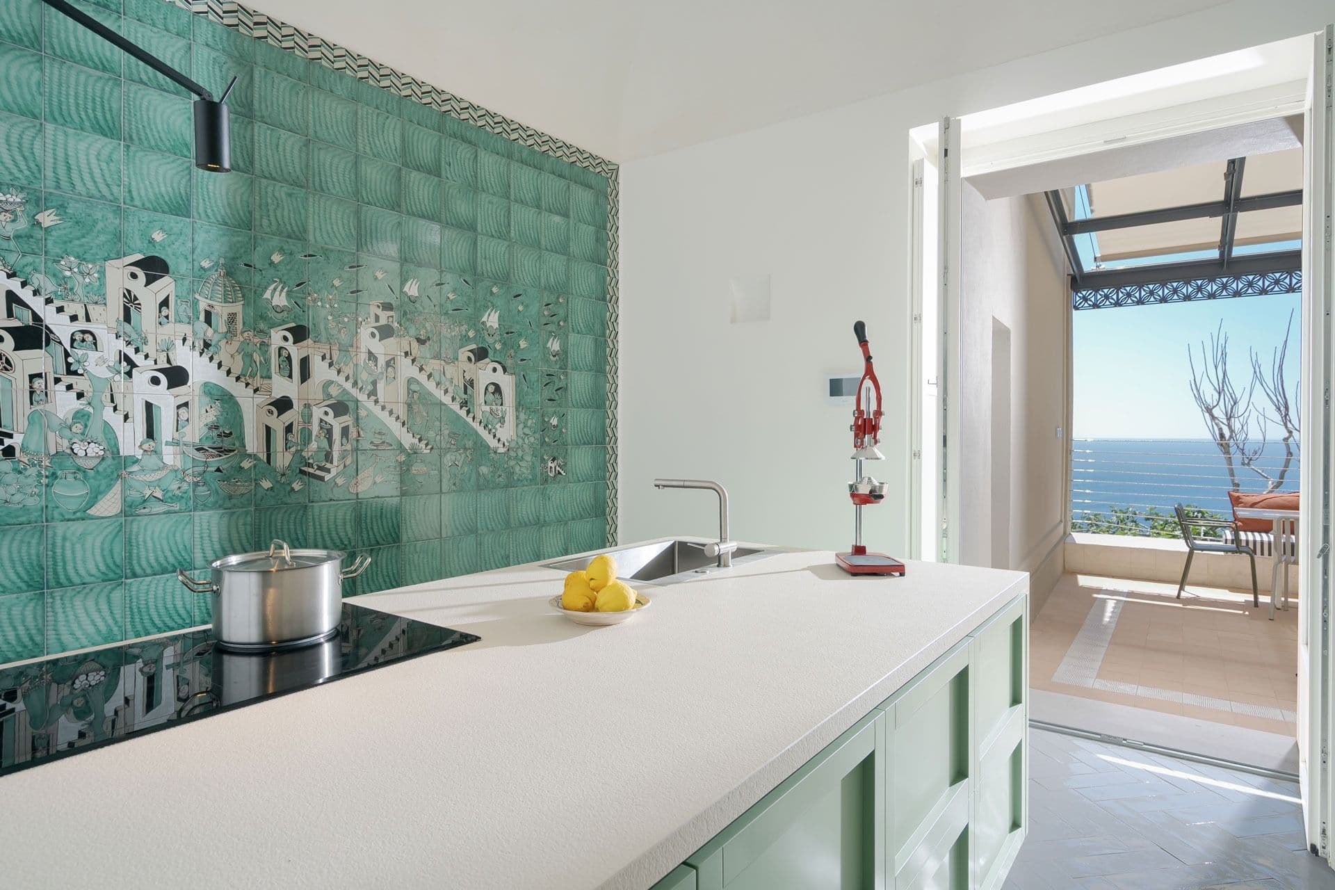 Green tiled kitchen with terrace access at Ocean House, Positano