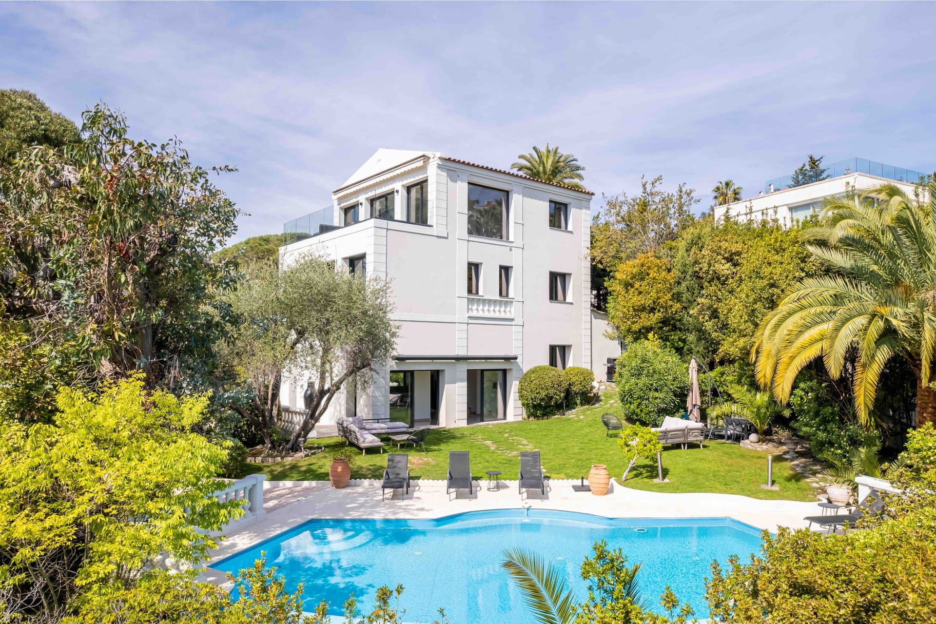 Aerial view of The Rosewood, a white contemporary villa in Cannes with a landscaped pool garden