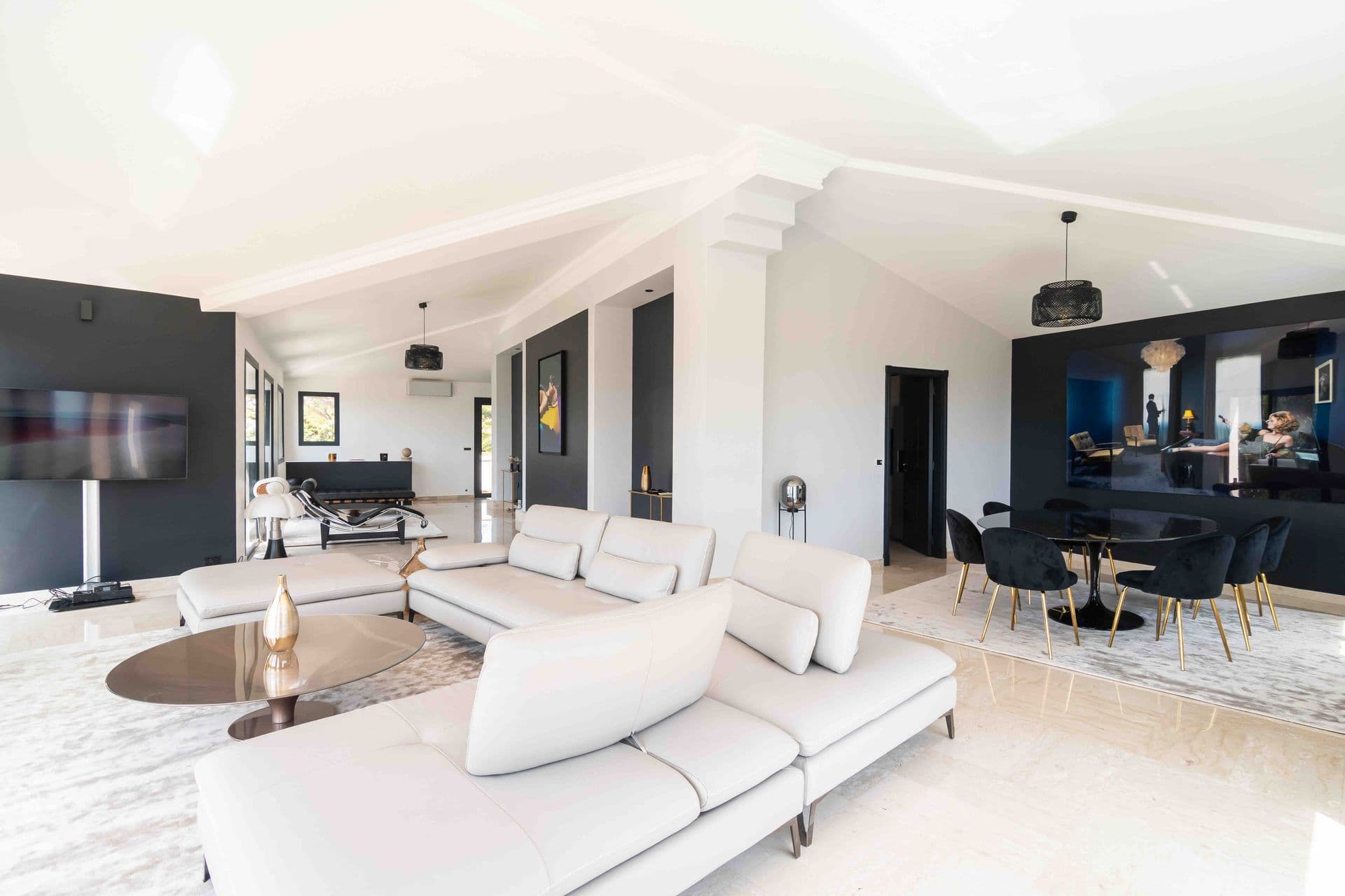An open plan living space with a white corner sofa and views through to the kitchen