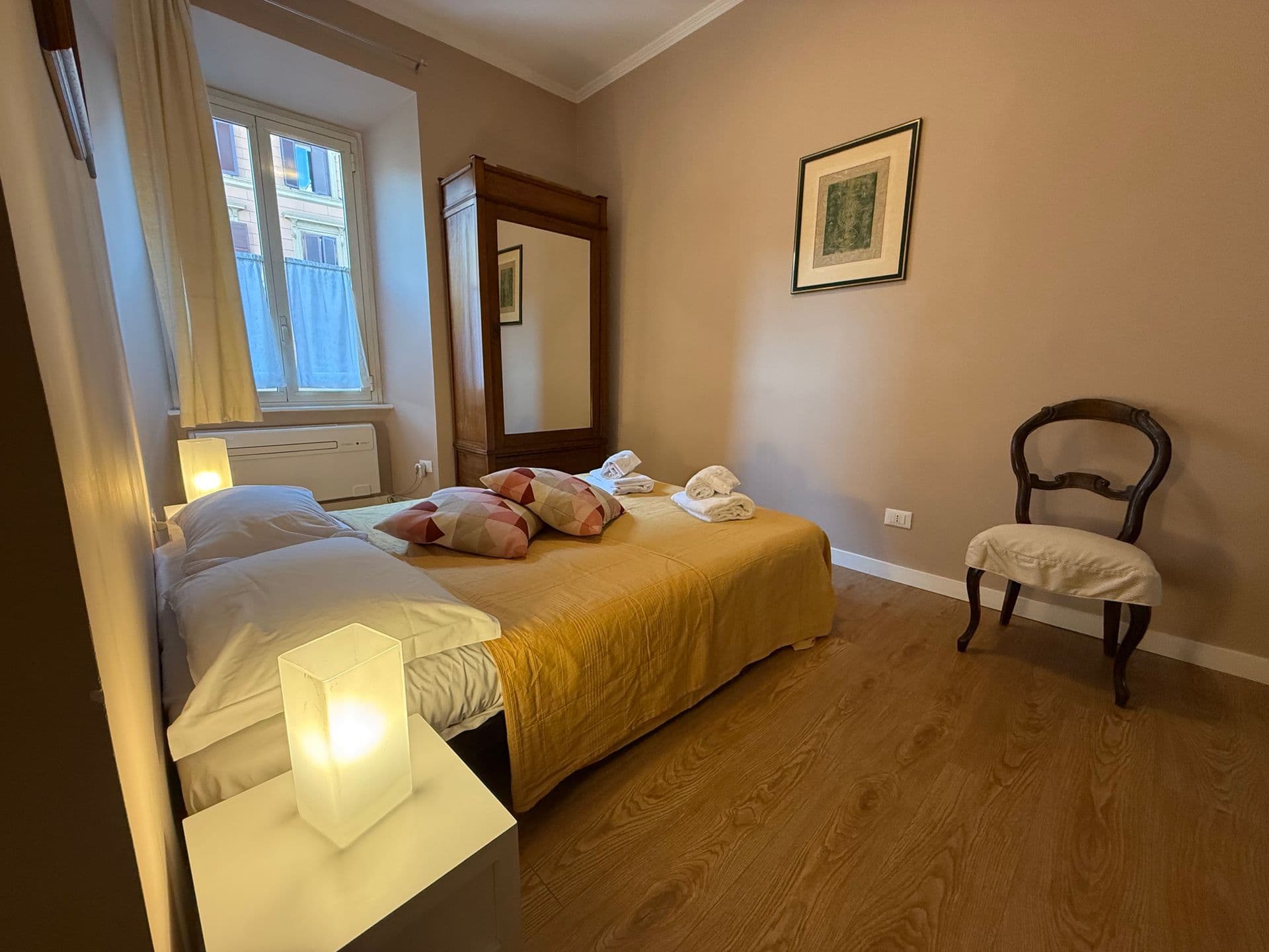 Cosy attic bedroom with sloped ceiling and yellow bedspread