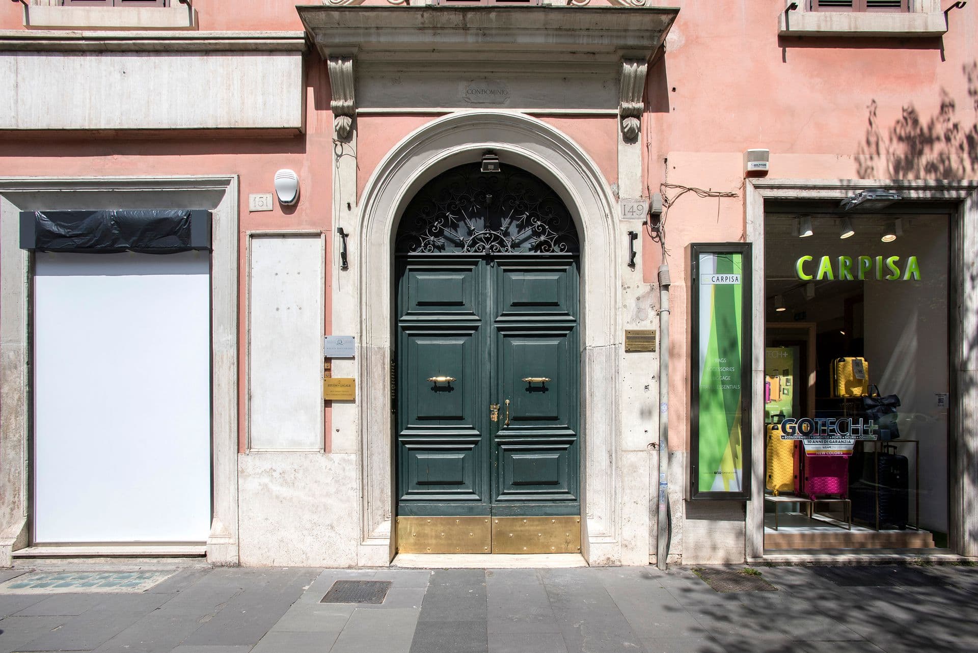 Green period entrance door to the building on a Rome street