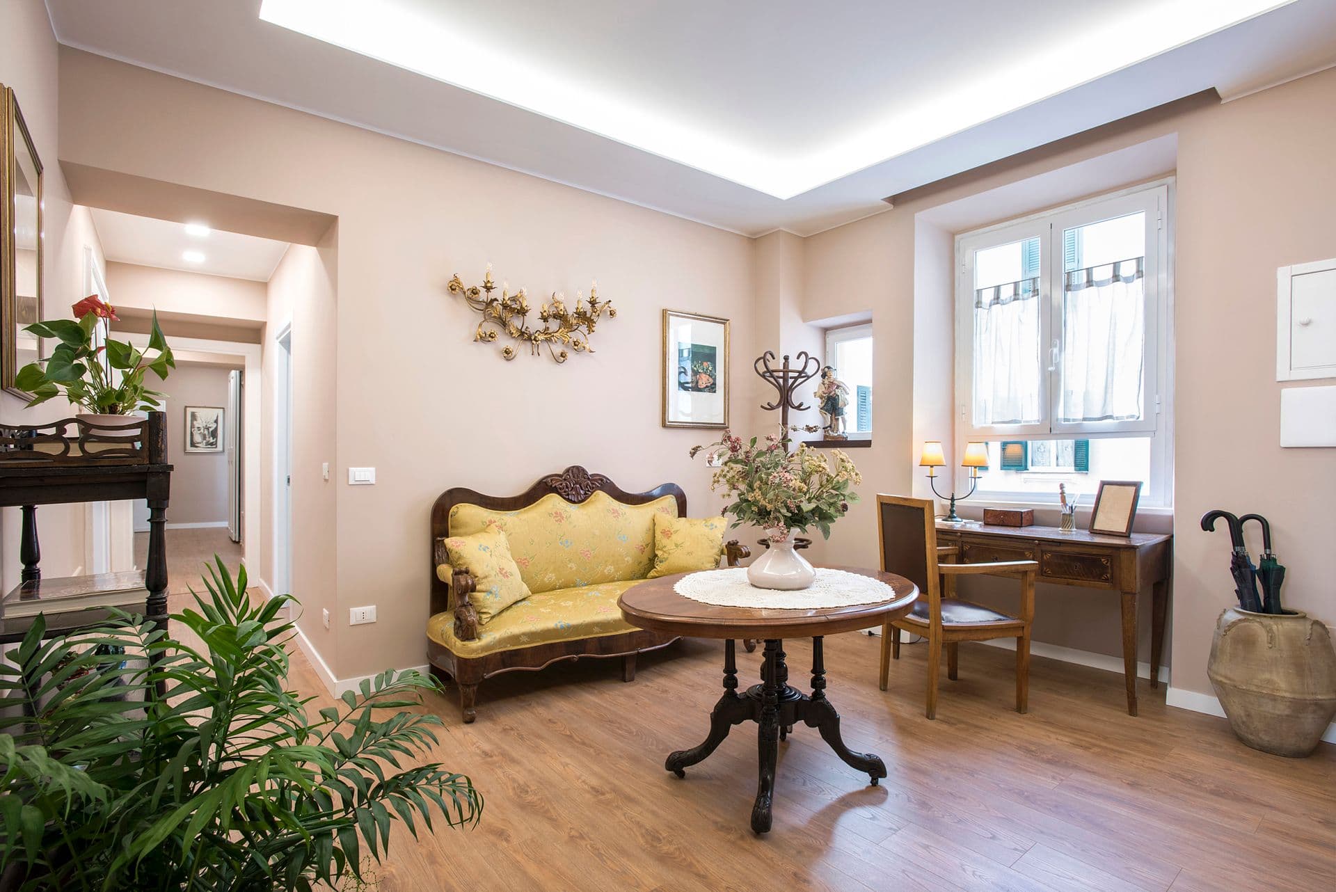 Living area with antique sofa and round dining table