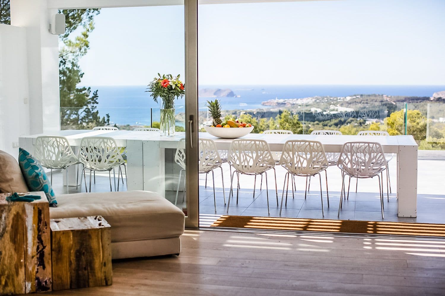 Outdoor dining table on a terrace with a distant sea view at Between Pines, Ibiza