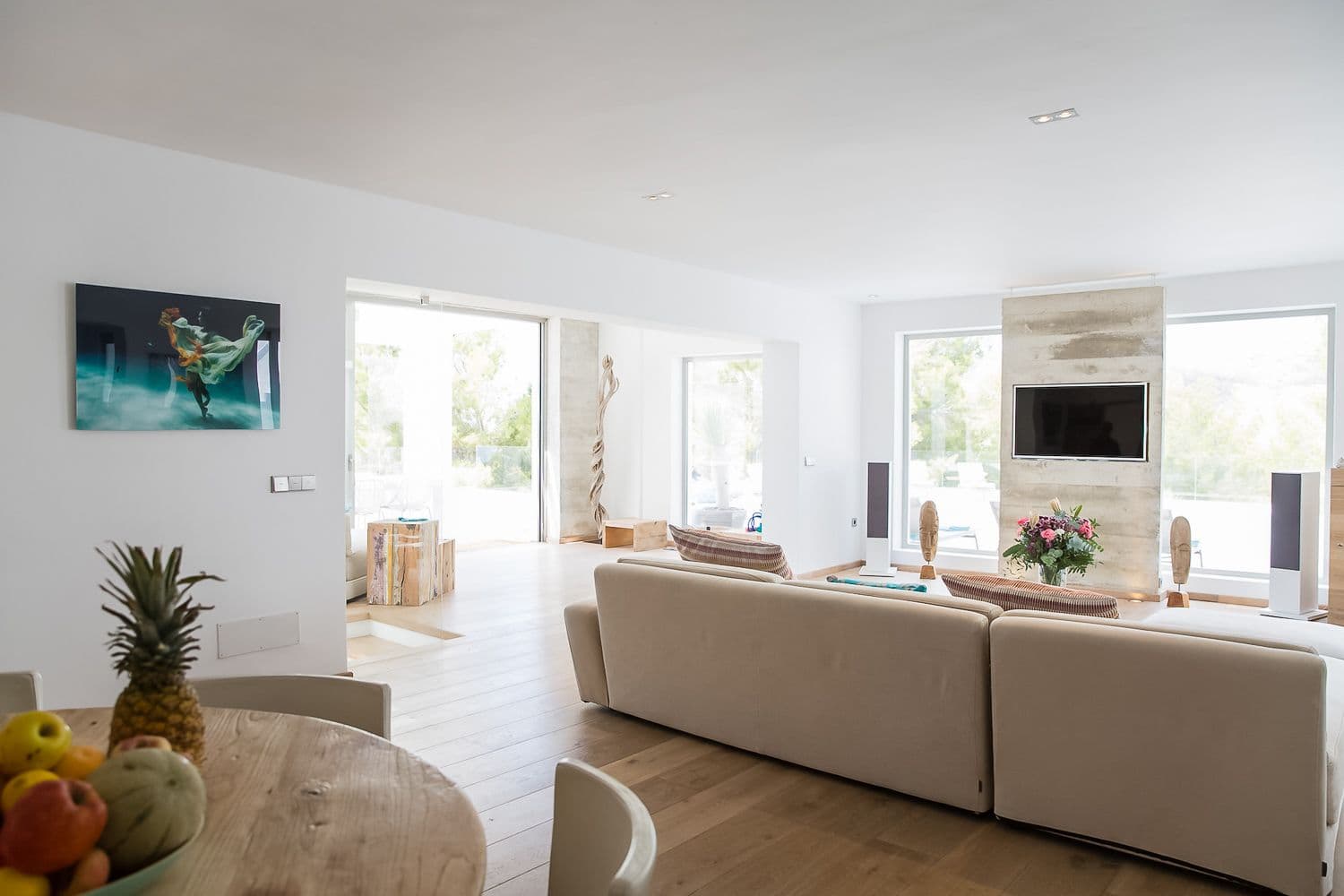 Bright living room with linen sofas opening to the terrace at Between Pines, Ibiza