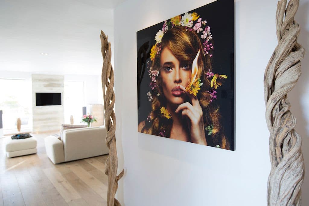 Sitting area with fashion artwork and driftwood mirrors at Between Pines, Ibiza