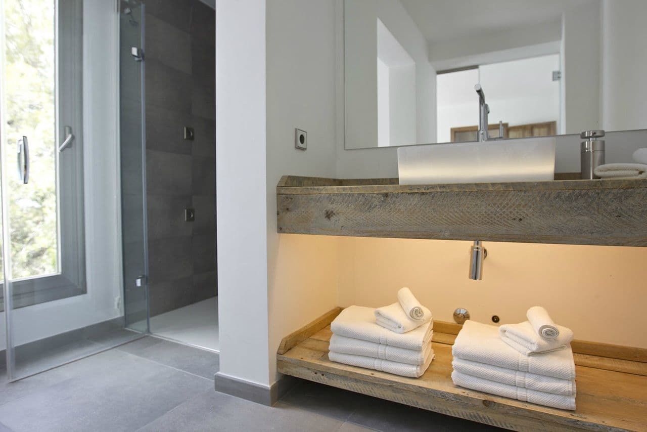 Bathroom with a reclaimed-timber vanity and walk-in shower at Between Pines, Ibiza