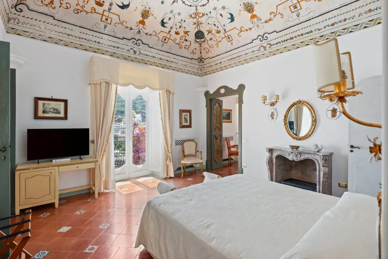 Bedroom with a hand painted ceiling and television