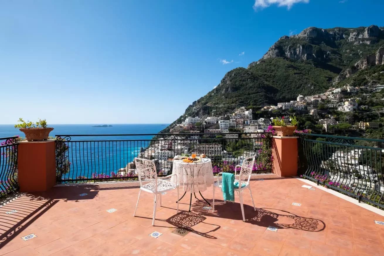 Terracotta terrace with wrought iron furniture overlooking the Positano coastline