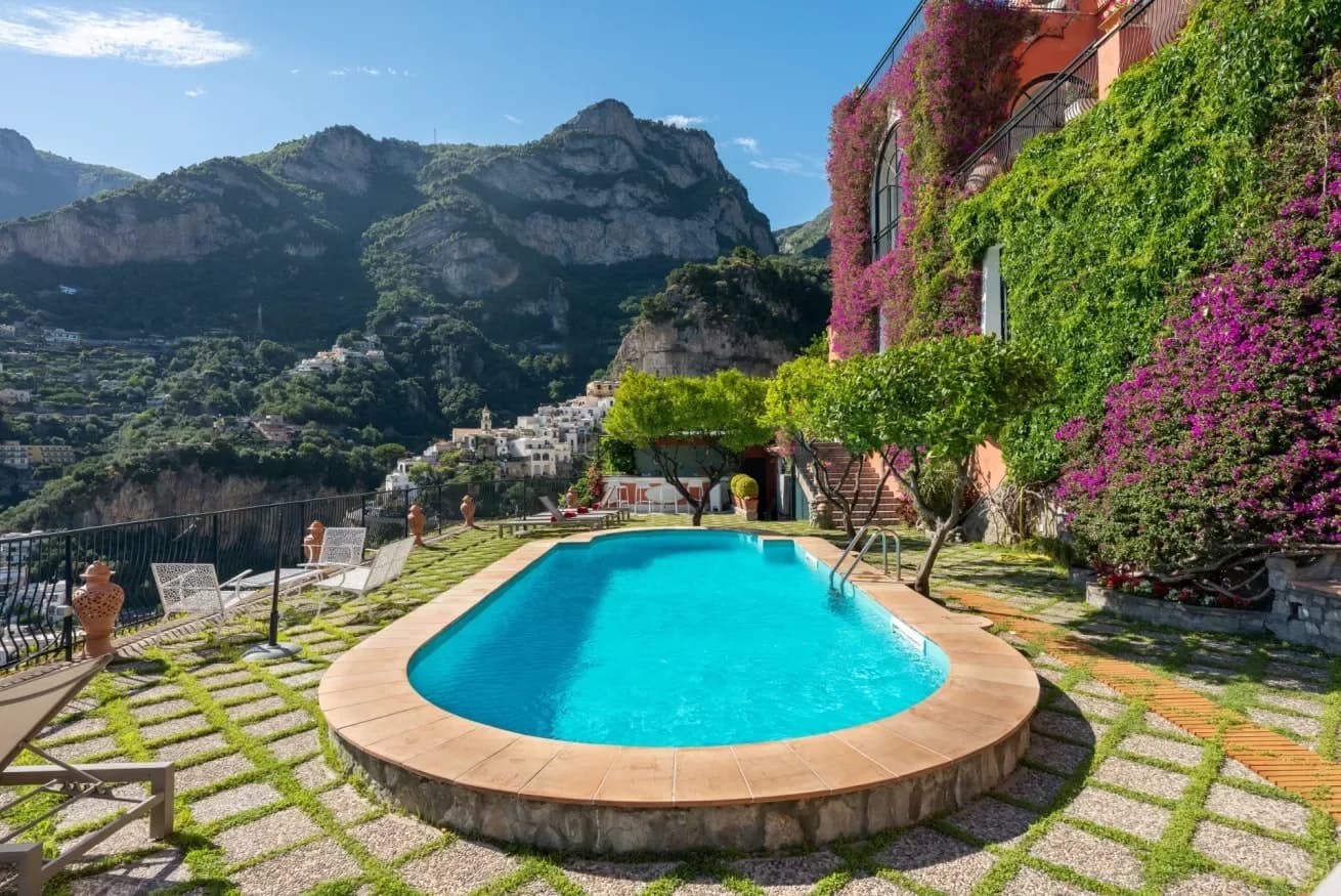 Vibrant Sunset oval pool with terraced gardens and bougainvillea, Positano, Amalfi Coast, Italy