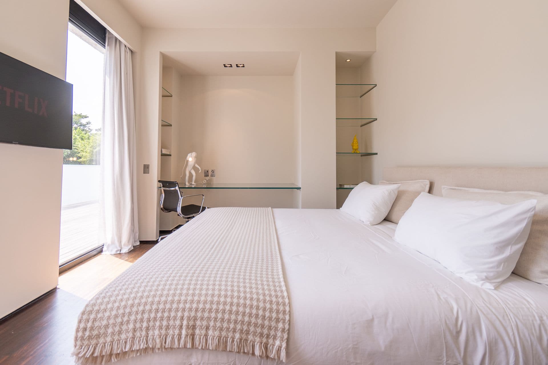Double bedroom opening through sliding glass to the garden at Elegant Lake Manor, Cernobbio