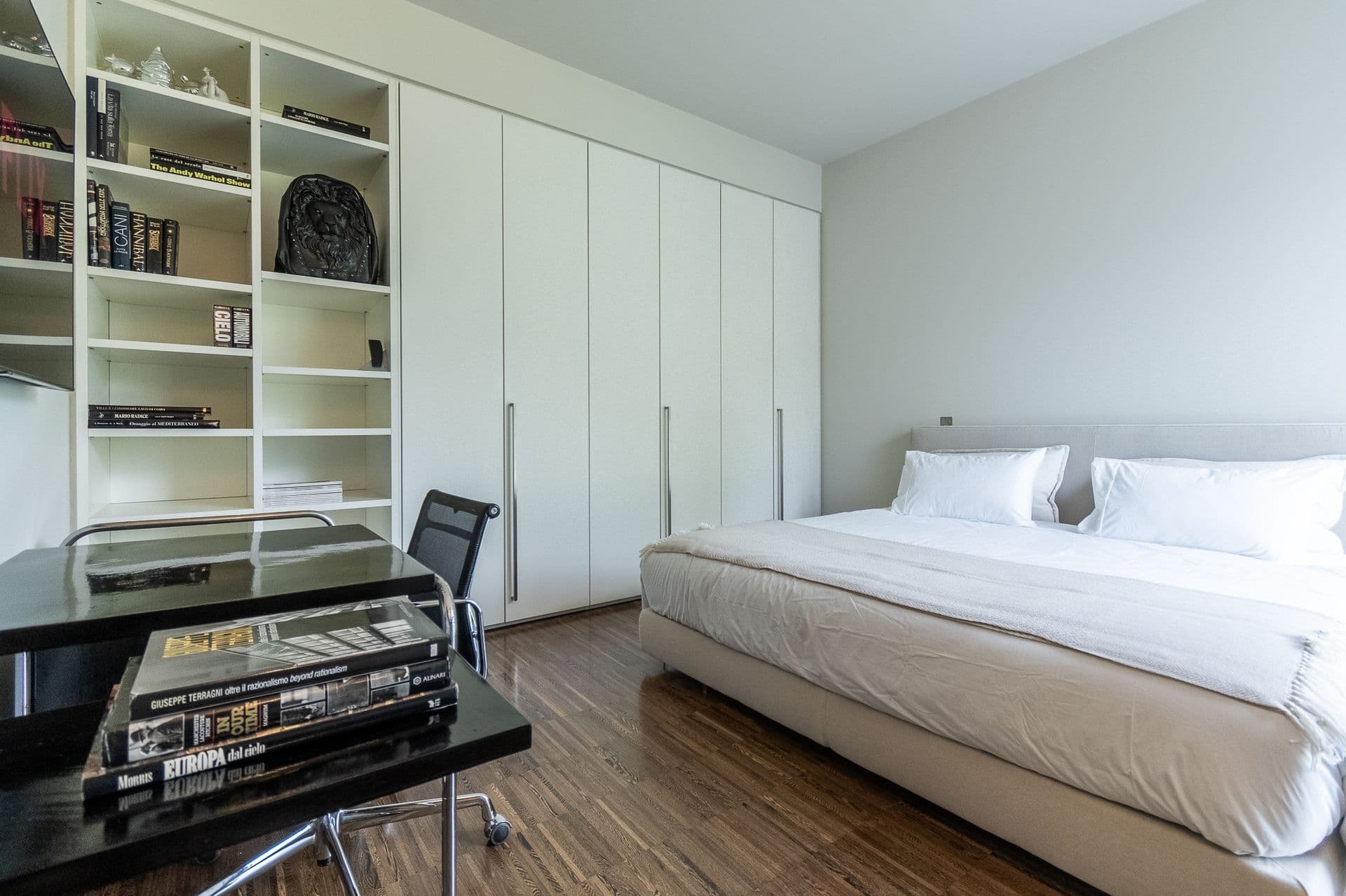Double bedroom with fitted white wardrobes and a study corner at Elegant Lake Manor, Cernobbio