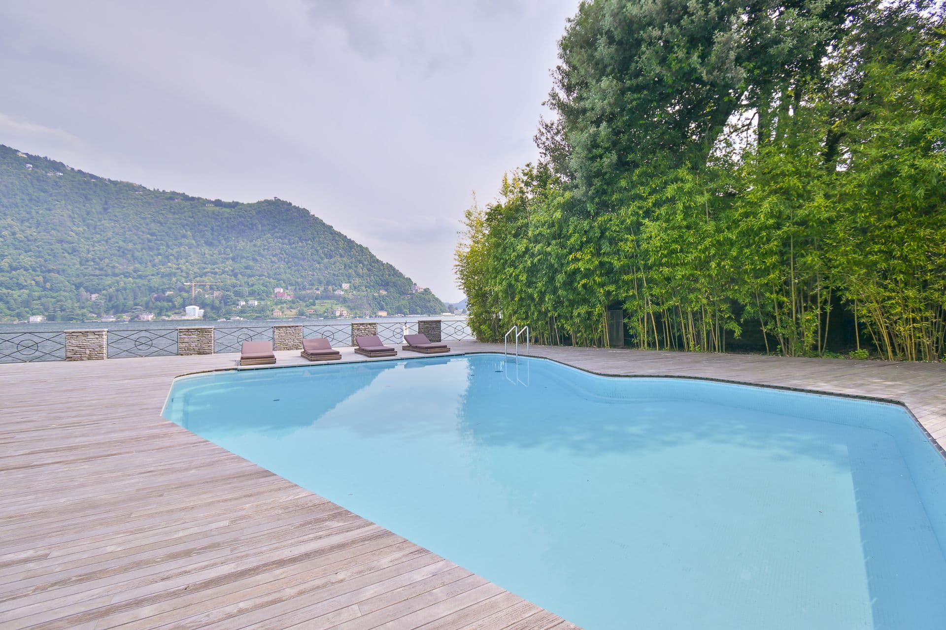 Swimming pool on a timber deck with lake and mountain views at Elegant Lake Manor, Cernobbio, Lake Como