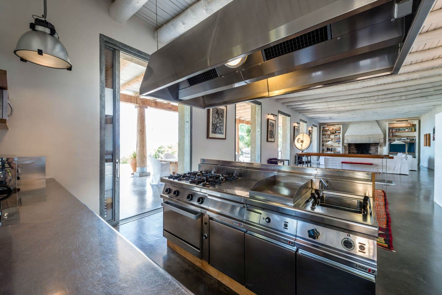 Professional-style kitchen with a commercial range and dark stone worktops