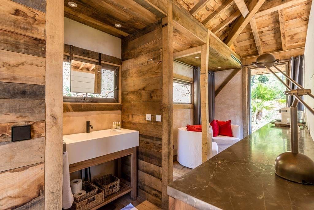 Ensuite bathroom with a reclaimed wood vanity and stone countertop