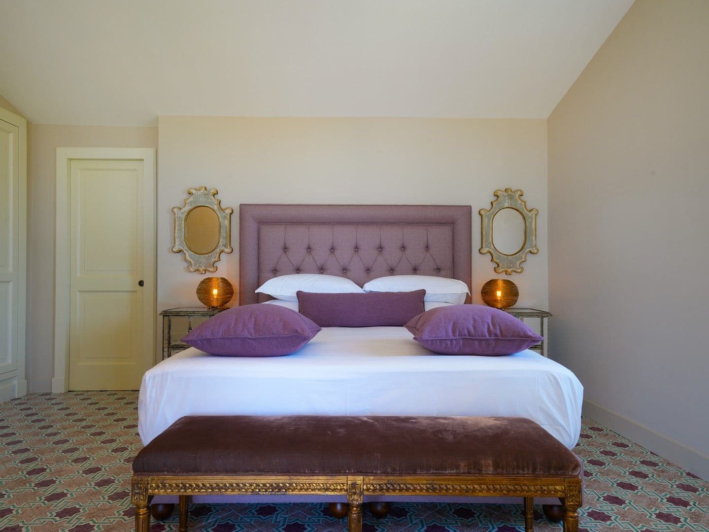 Double bedroom with a plum velvet headboard and gilt mirrors at Casarlano Sunsets, Sorrento
