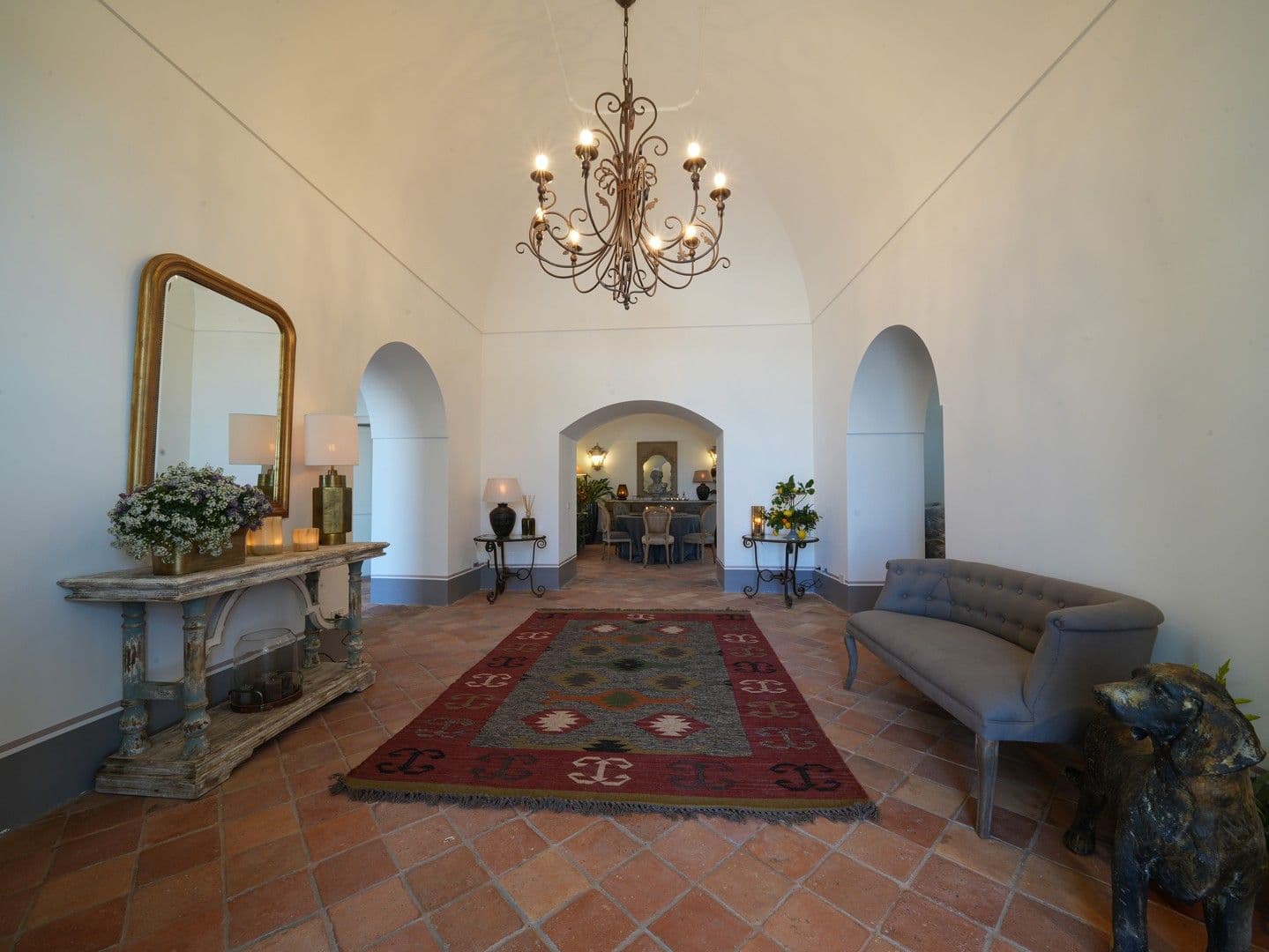 Grand vaulted entrance hall with kilim rugs and antique consoles at Casarlano Sunsets, Sorrento
