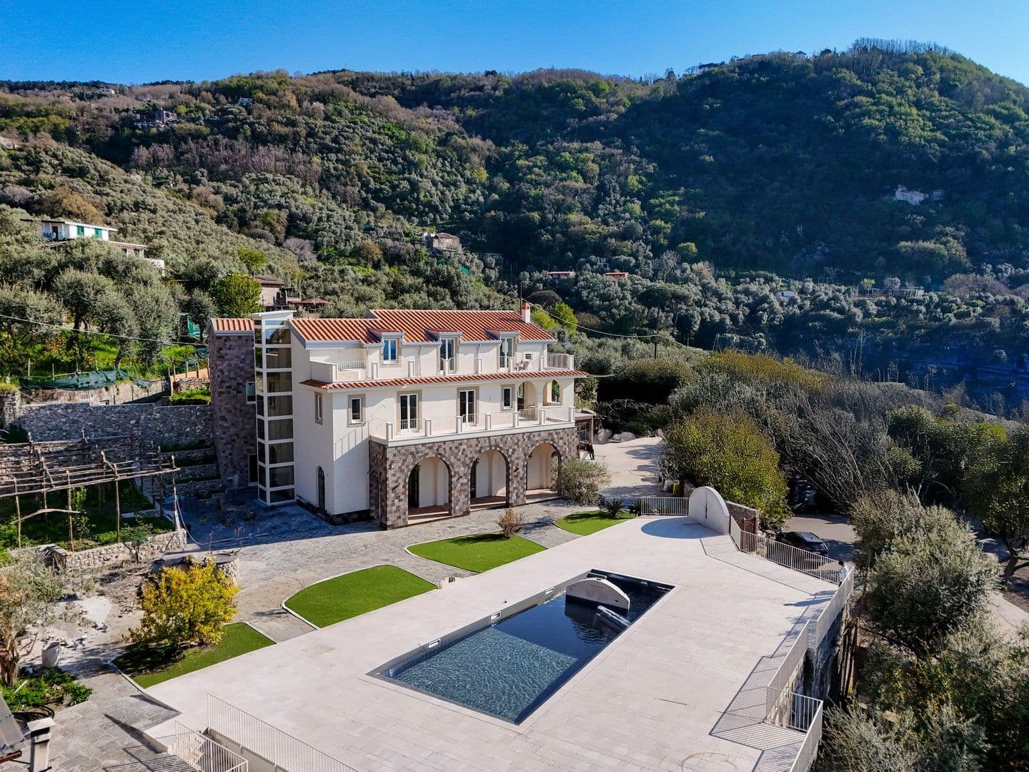 Historic stone villa with a pool set into terraced hillside gardens above Sorrento at Casarlano Sunsets, Italy