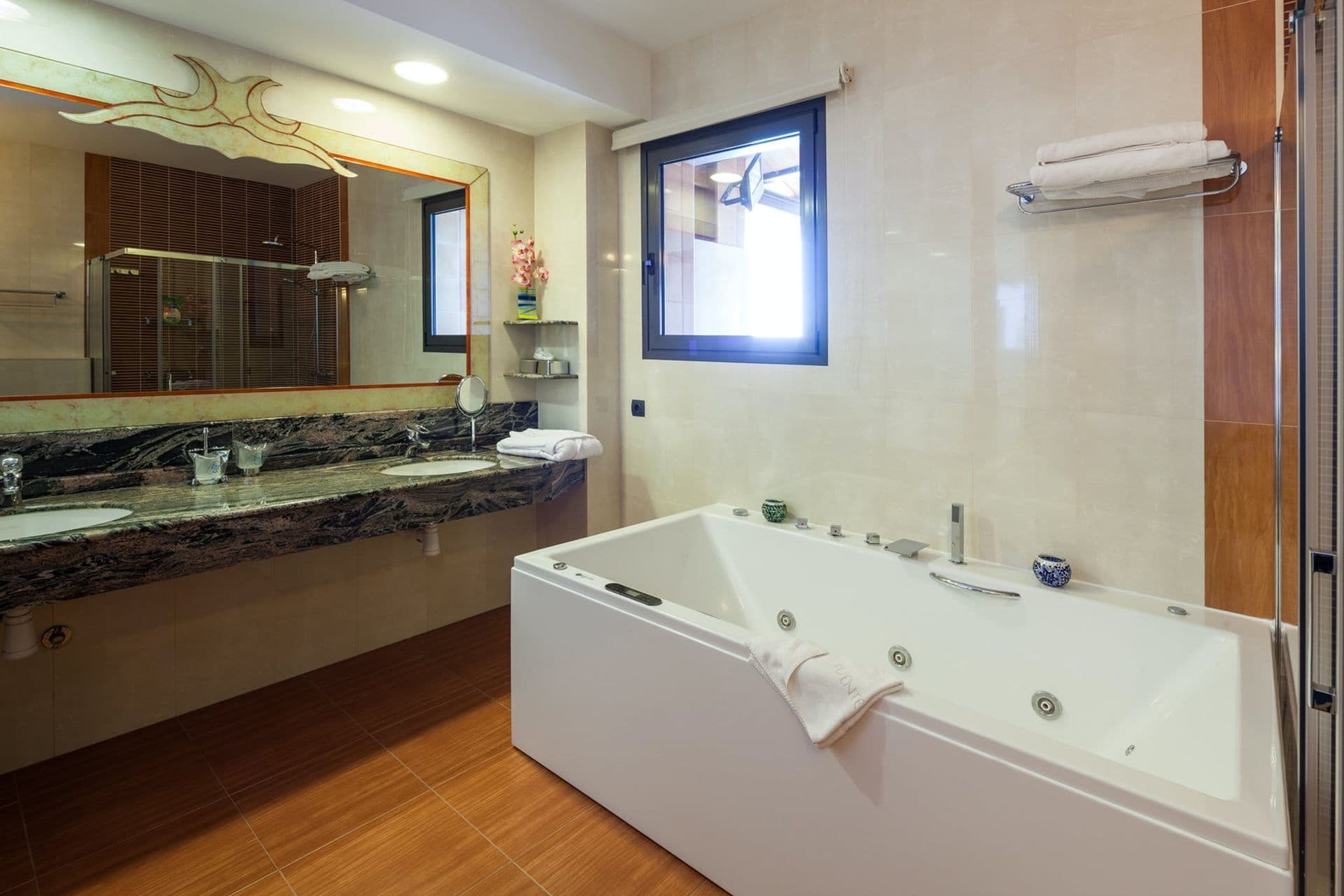 En-suite bathroom with a black marble jacuzzi bathtub