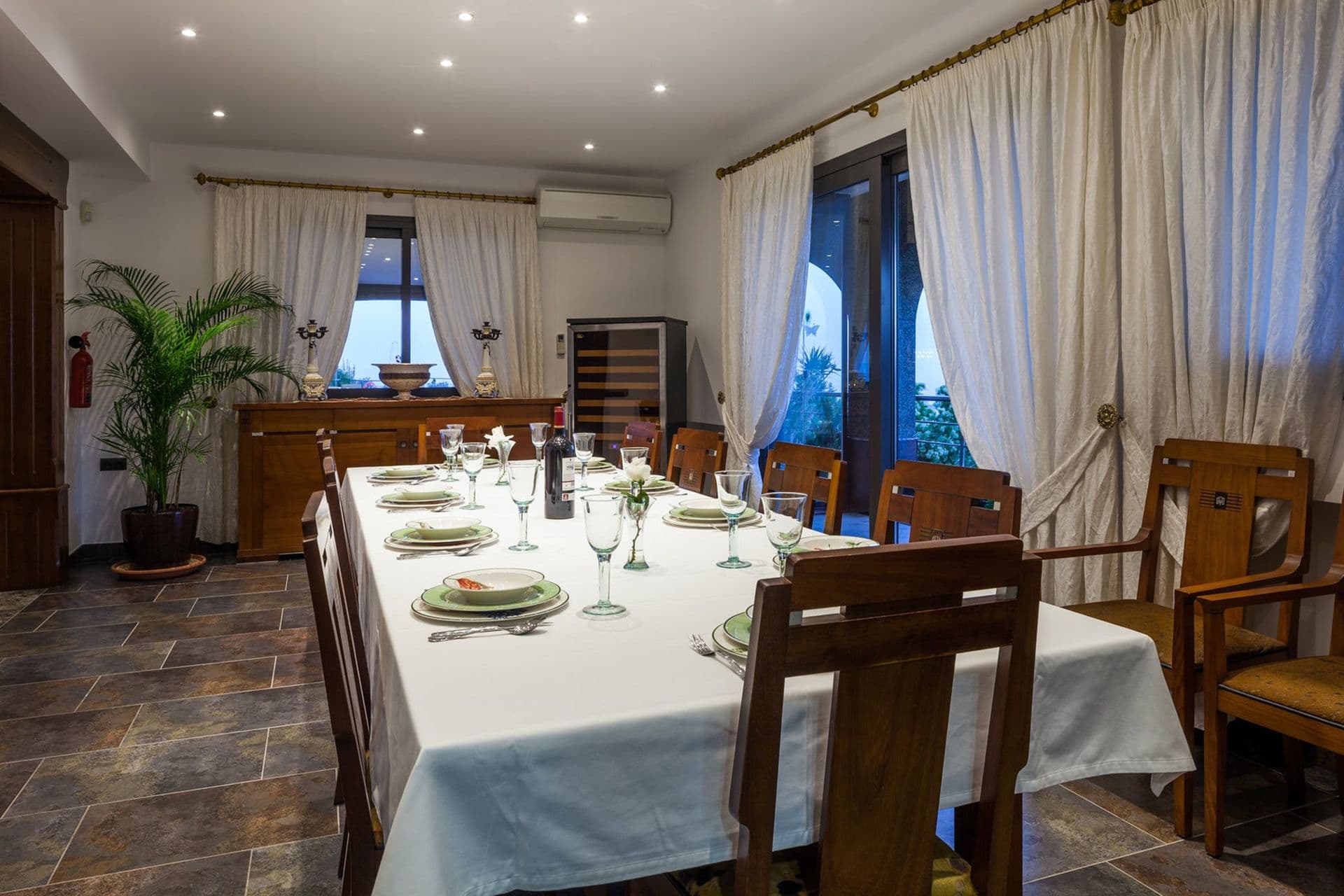 Formal dining room with a white-clothed table set for six