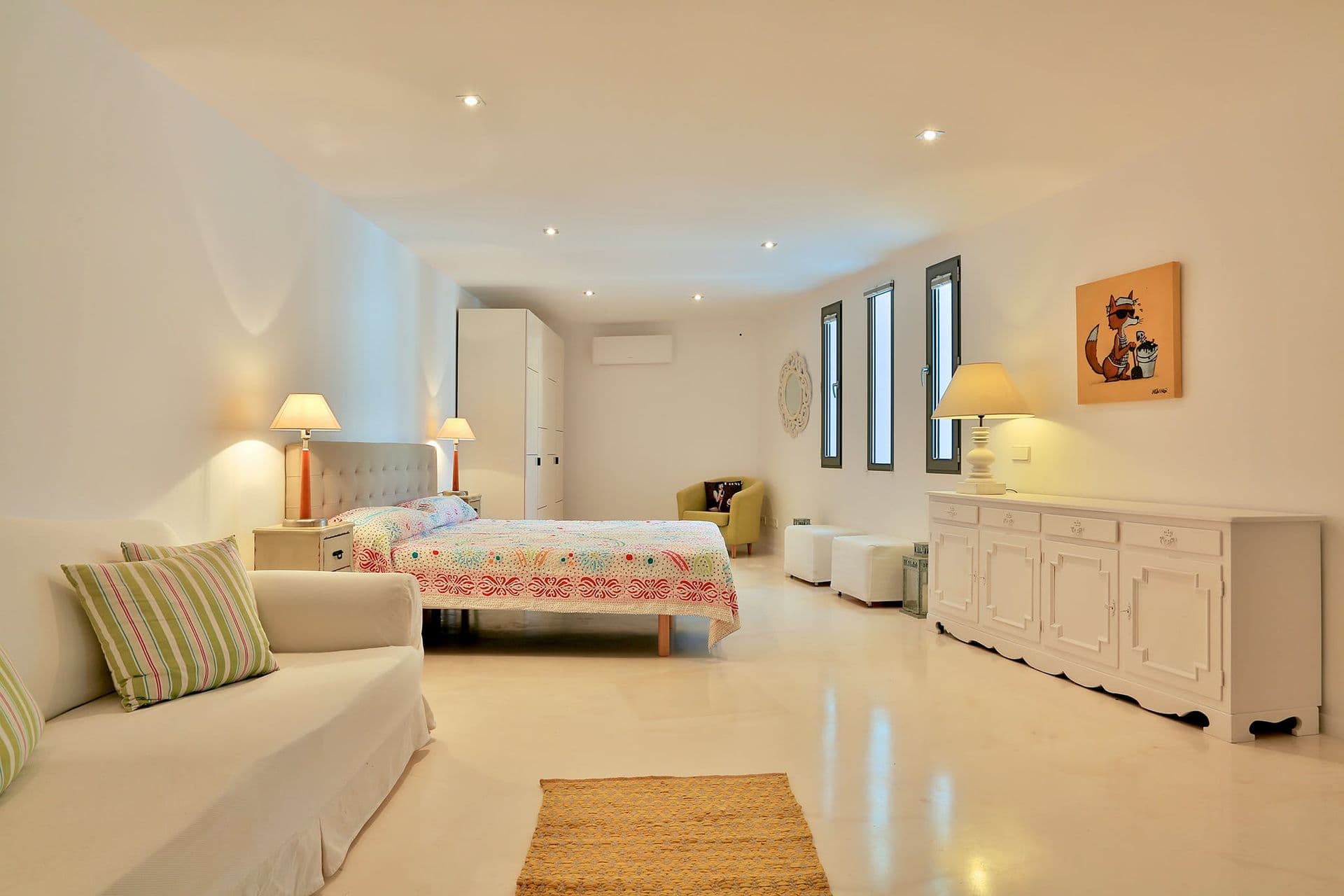 Twin bedroom with striped cushions and a vintage sideboard at Hazy Island View
