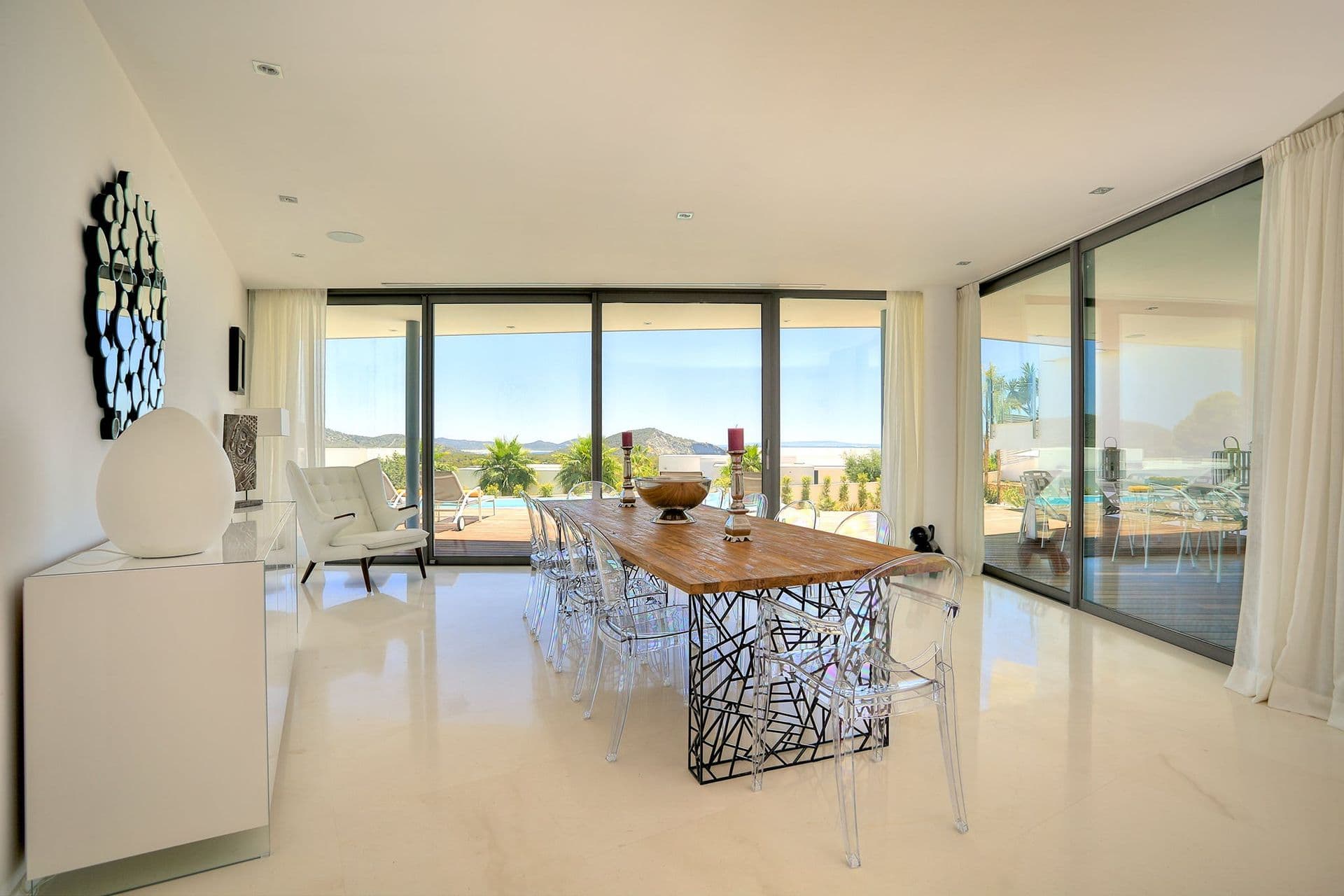 Dining room with floor-to-ceiling glass walls and countryside views at Hazy Island View