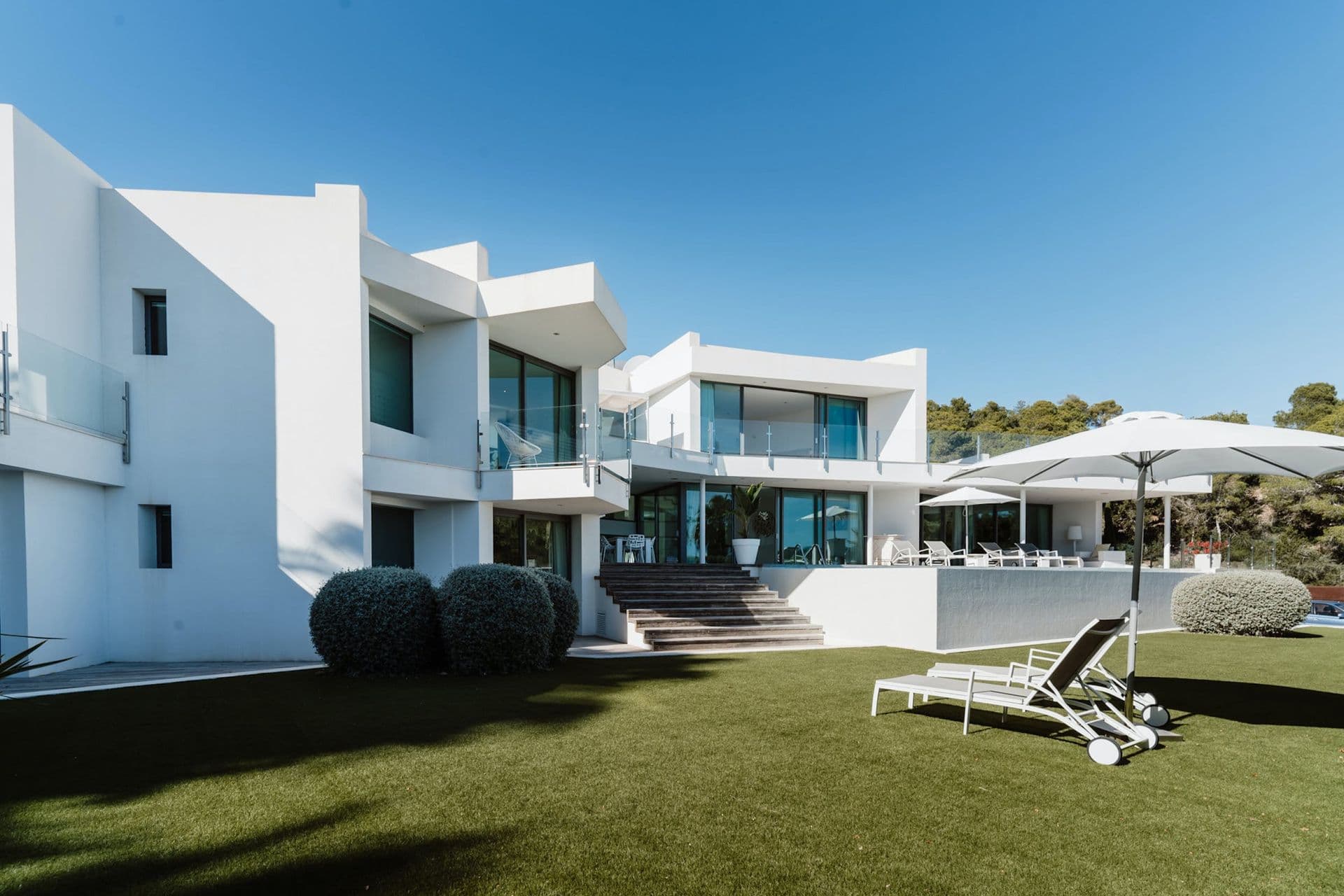 Villa exterior with manicured lawn and terraced steps at Hazy Island View