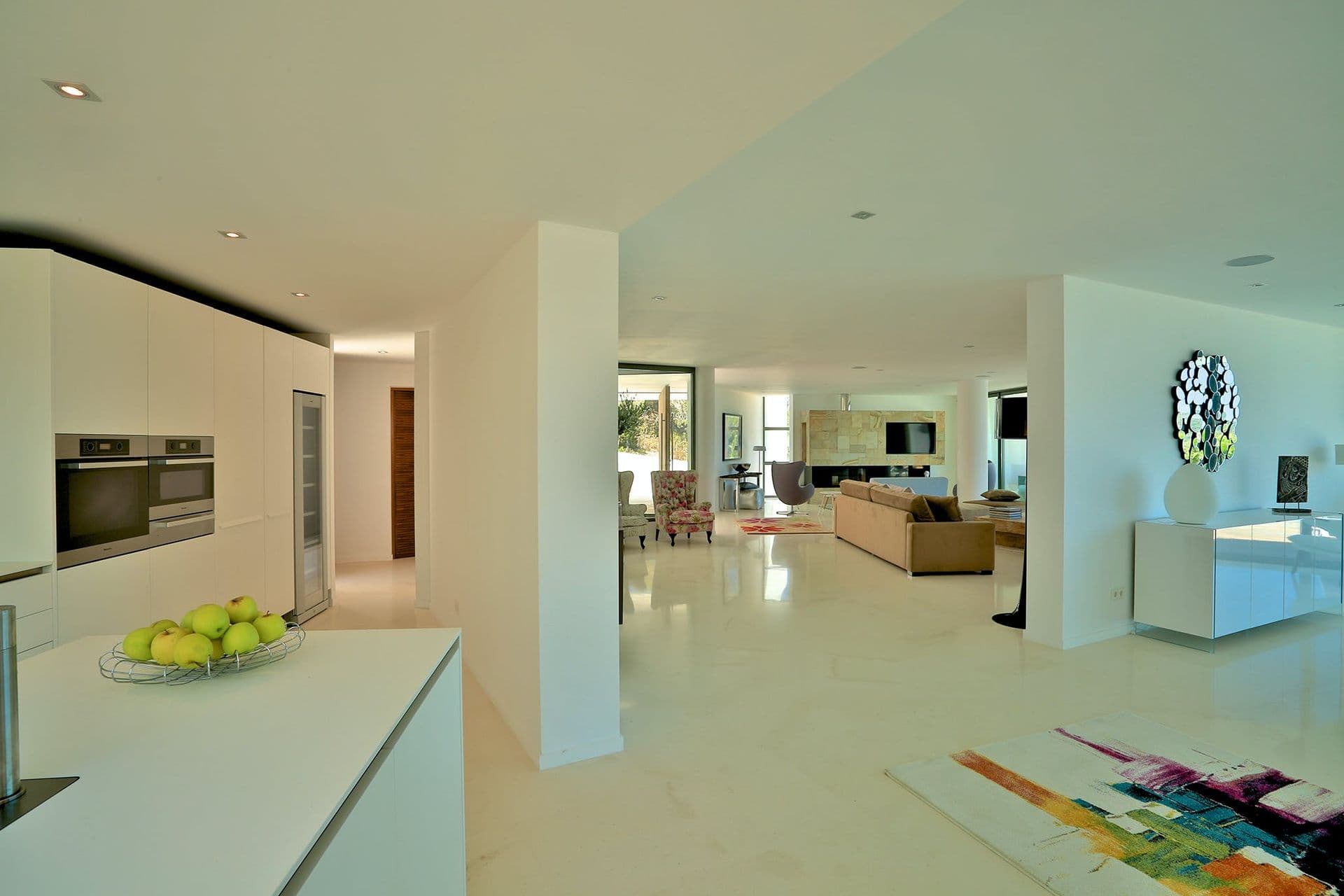High-gloss white kitchen with integrated appliances at Hazy Island View