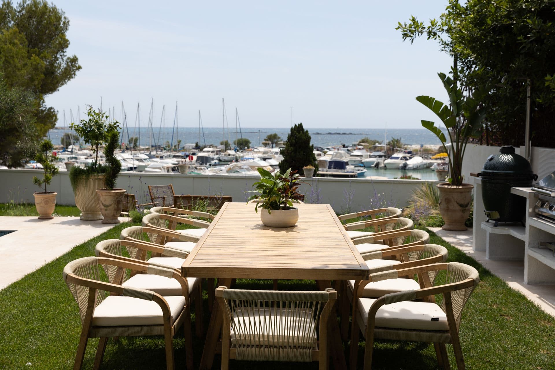 Long outdoor dining table with rattan chairs overlooking the harbour at Cote D'Azur Sunshine, Antibes