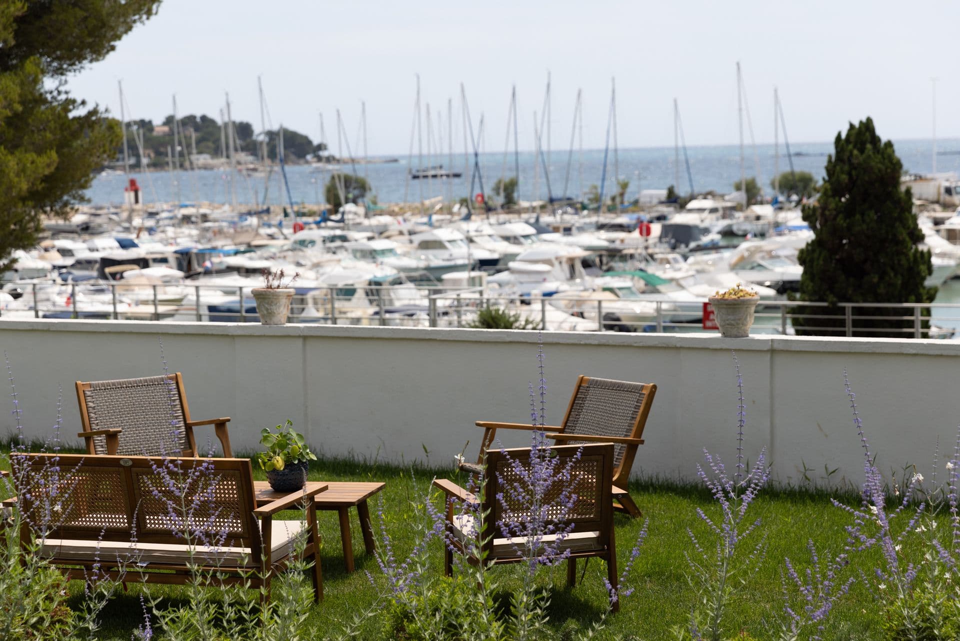 Garden seating on the lawn looking across the marina to the sea at Cote D'Azur Sunshine, Antibes
