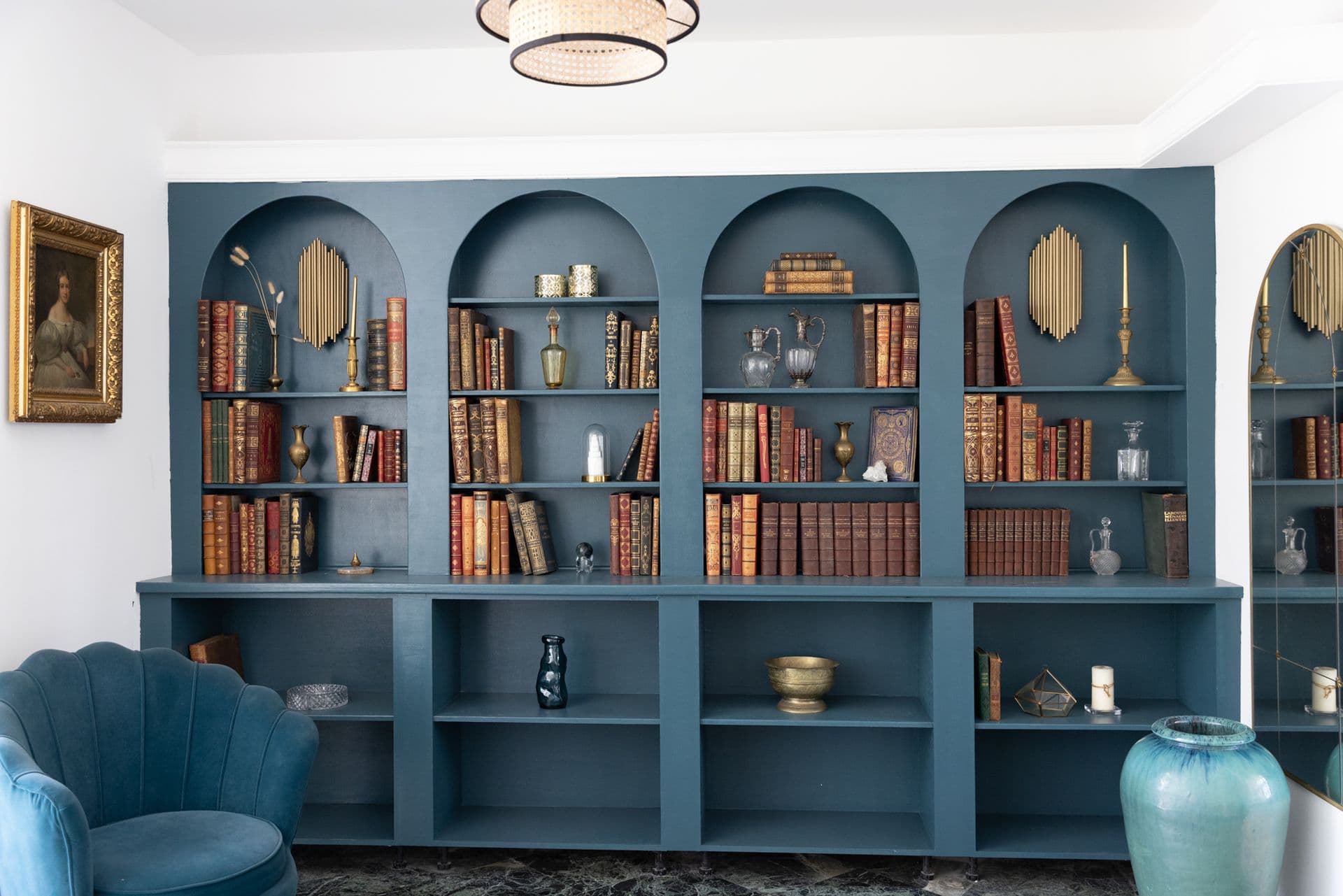 Living room with a grey sofa beside a blue arched bookcase at Cote D'Azur Sunshine, Antibes
