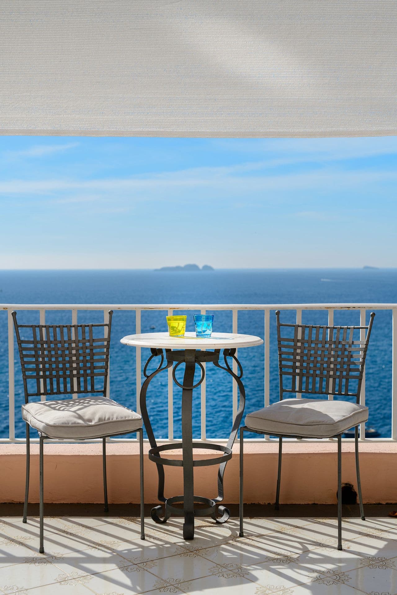 Private balcony with a bistro table and uninterrupted sea views