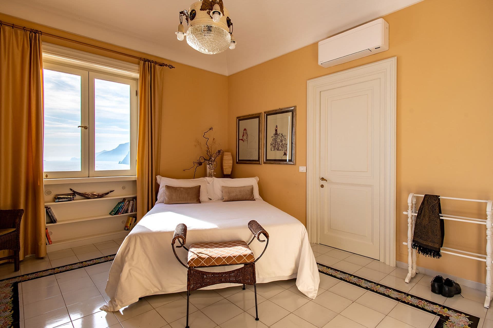 Guest bedroom in soft yellow tones with a garden-facing window